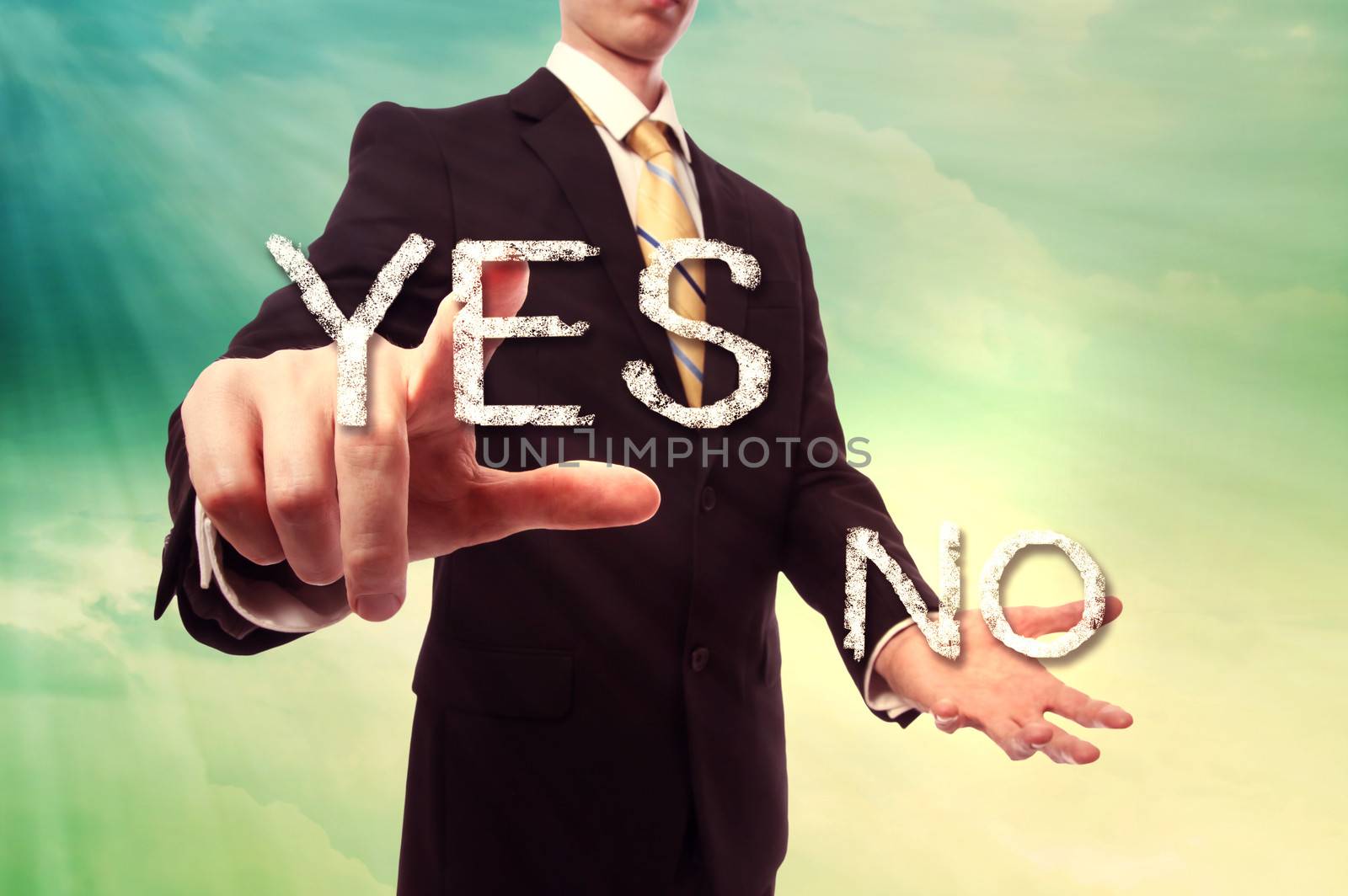 Businessman pointing YES over turquoise yellow colored sky background