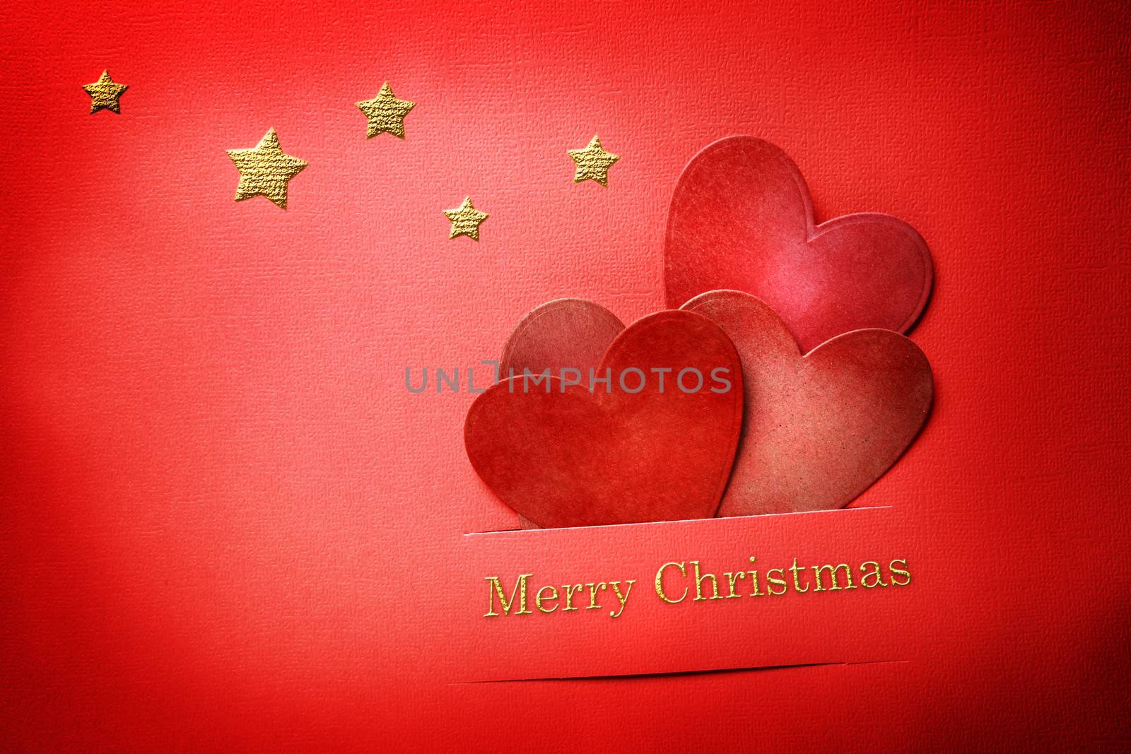 Handmade paper craft Christmas hearts with Merry Christmas text and stars 