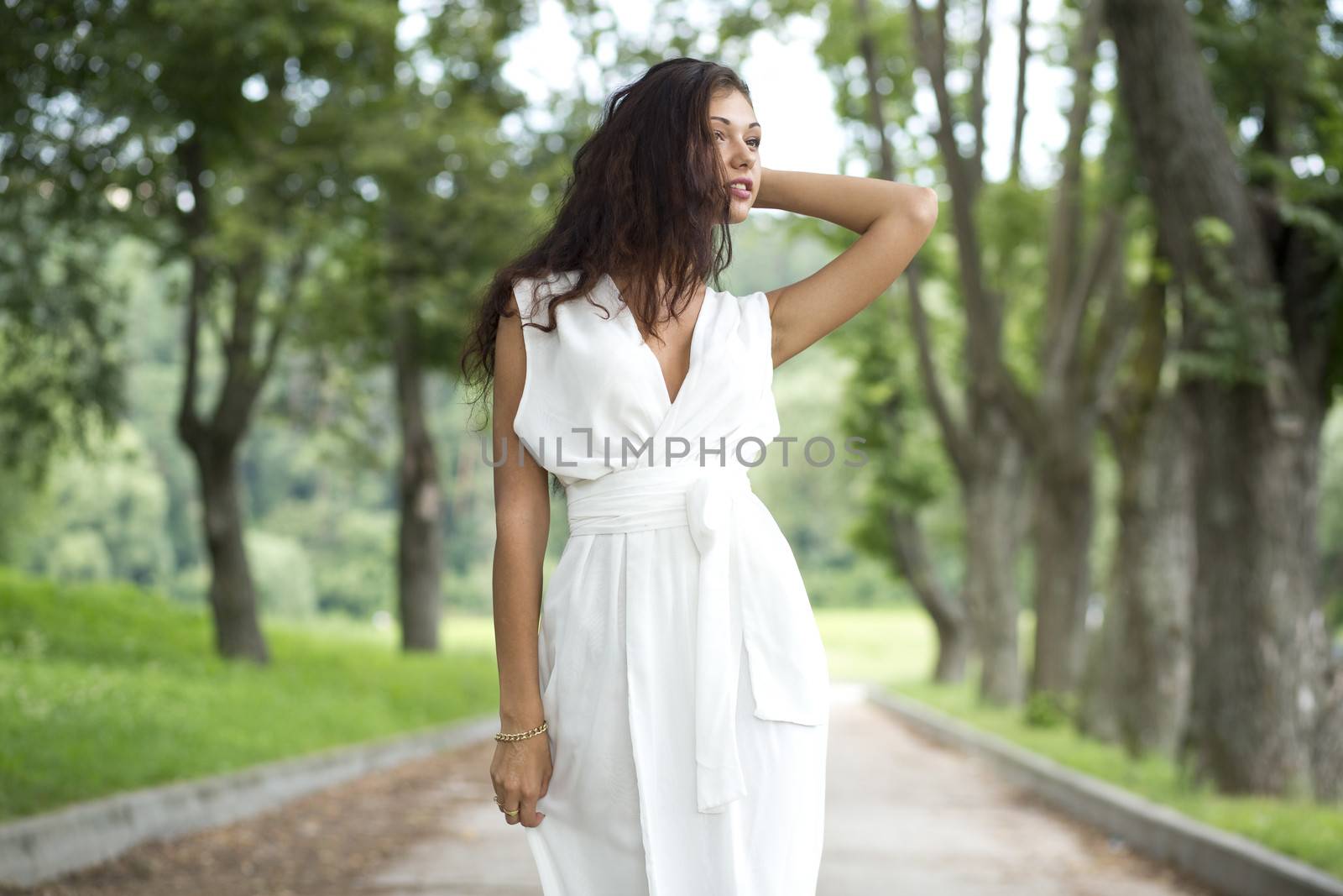 Happy woman in a white dress on the street
