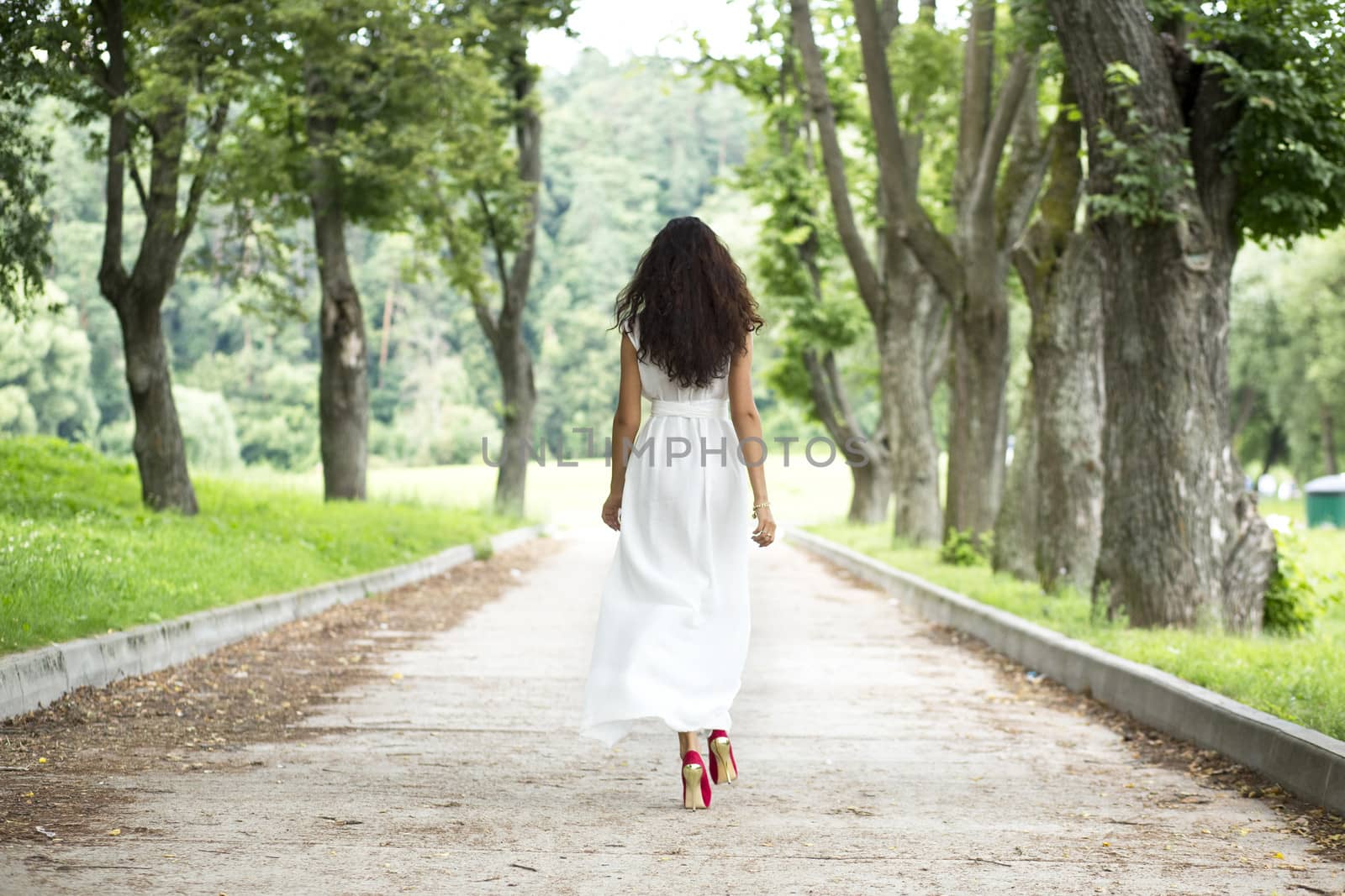 Full growth, beautiful young woman in white dress