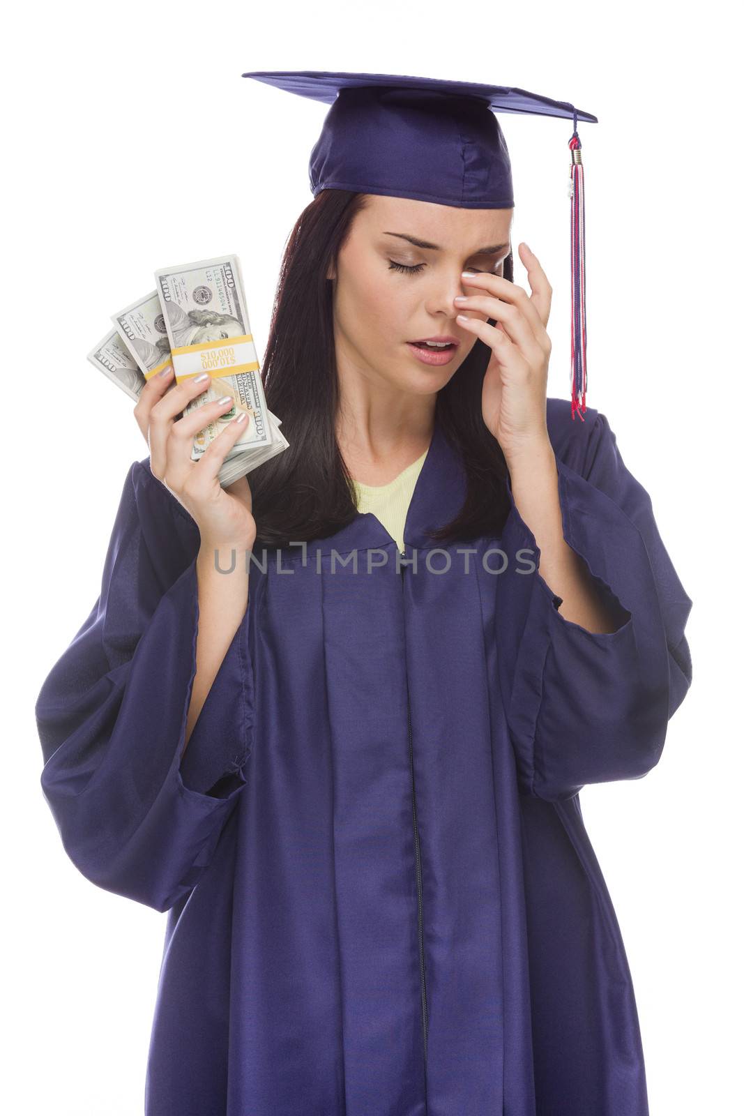 Stressed Female Graduate in Cap and Gown Holding Stacks of Hundred Dollar Bills Isolated on a White Background.