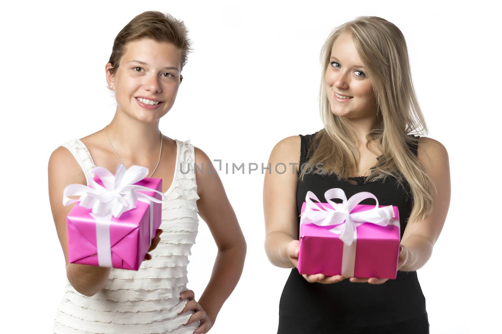 Two happy women, a blond with black top and a brunette with white top, holding a christmas or brithday present, isolated on white background