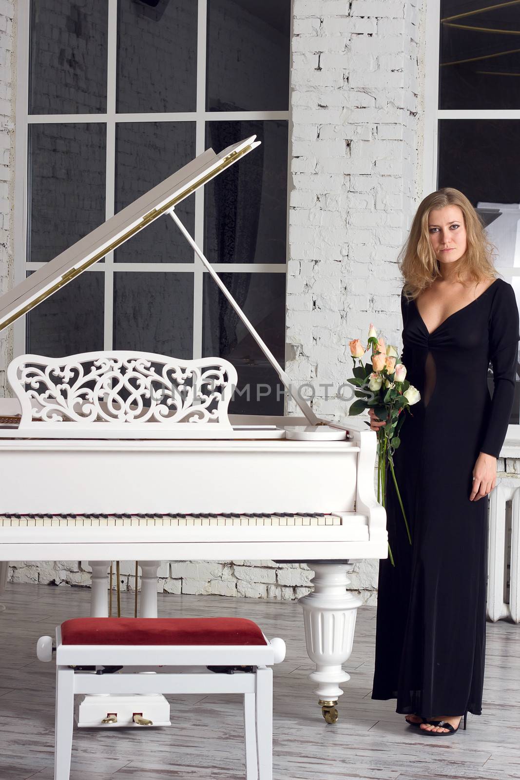 A beautiful young woman playing piano