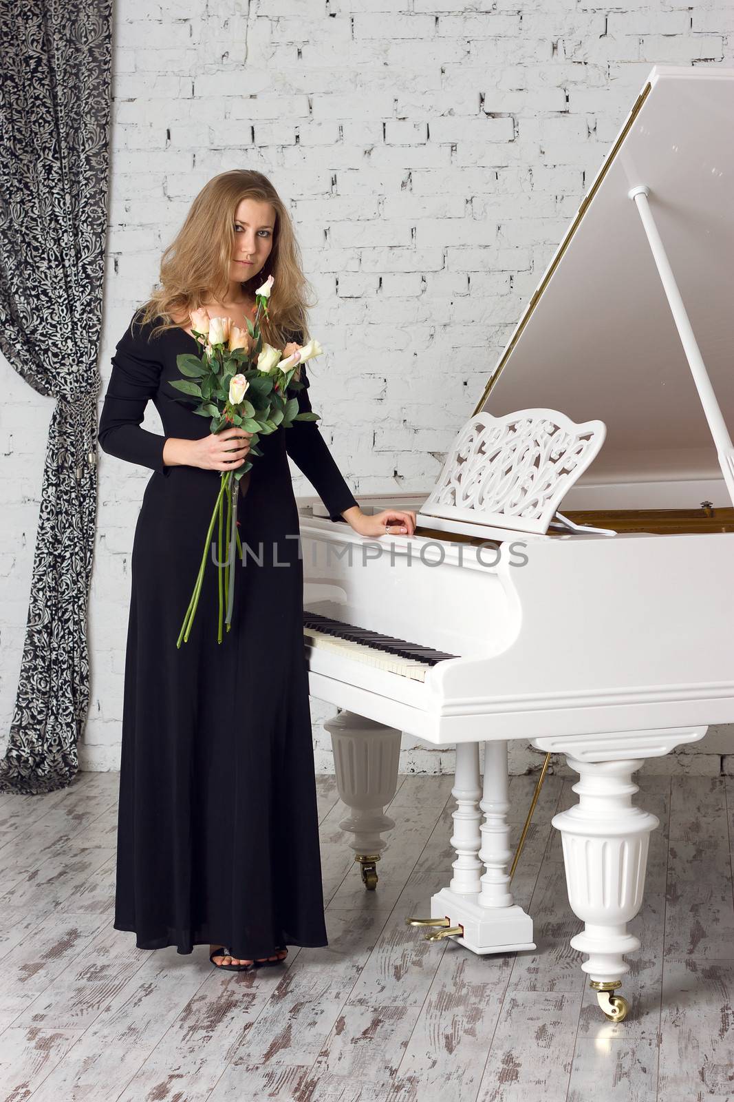 A beautiful young woman playing piano
