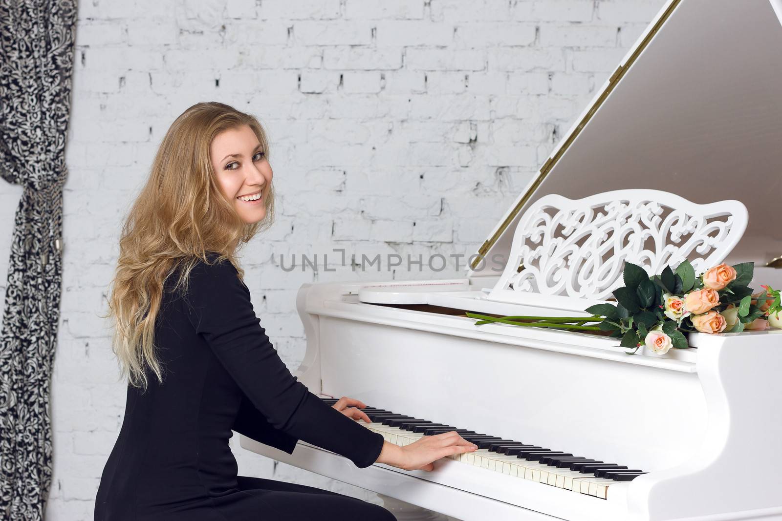 beautiful young woman playing the white piano