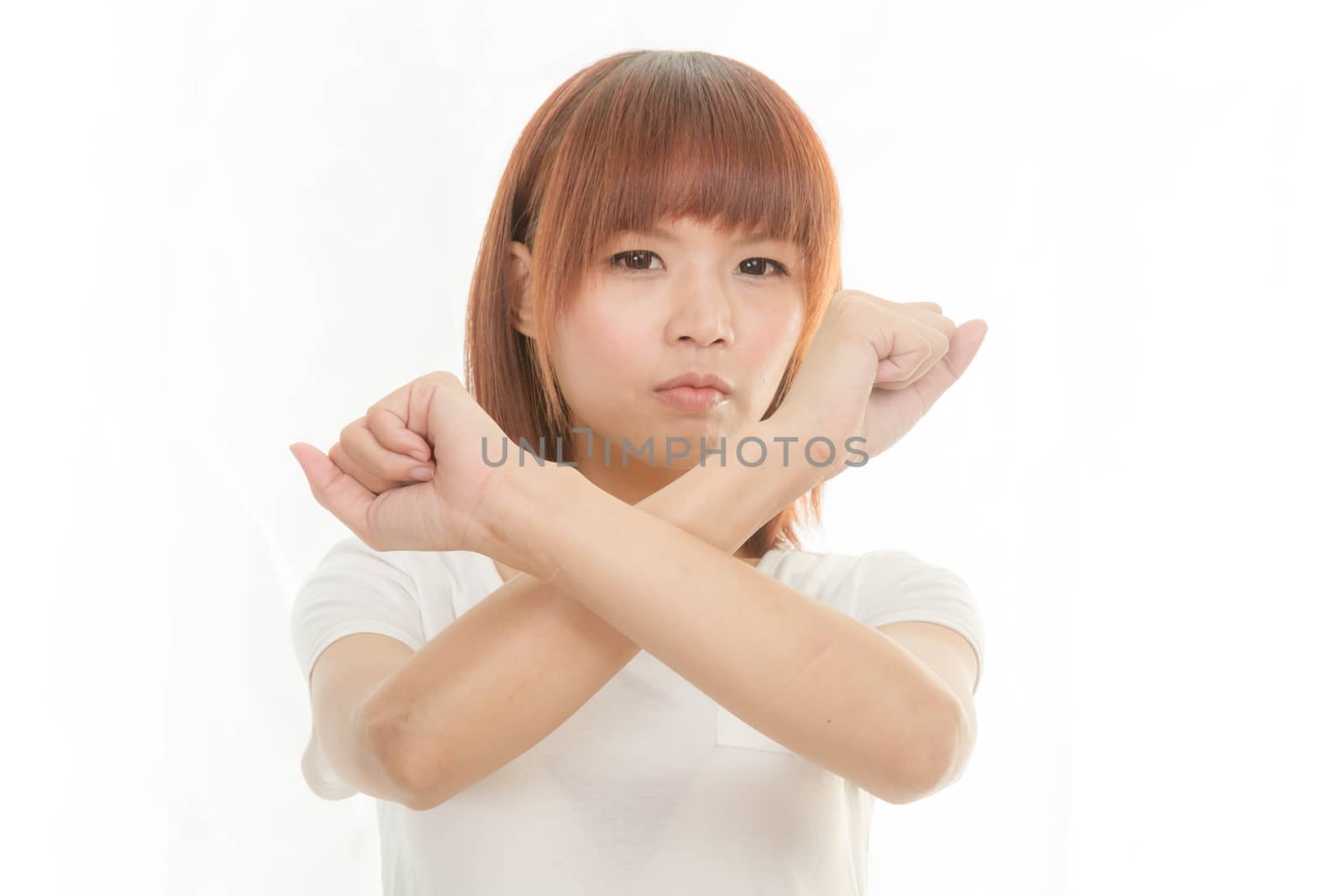 Young Asian woman making stop gesture over white background