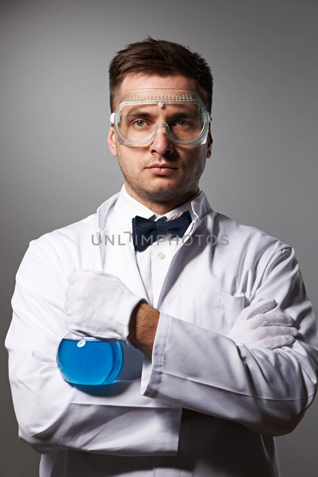 Scientist in glasses against grey background