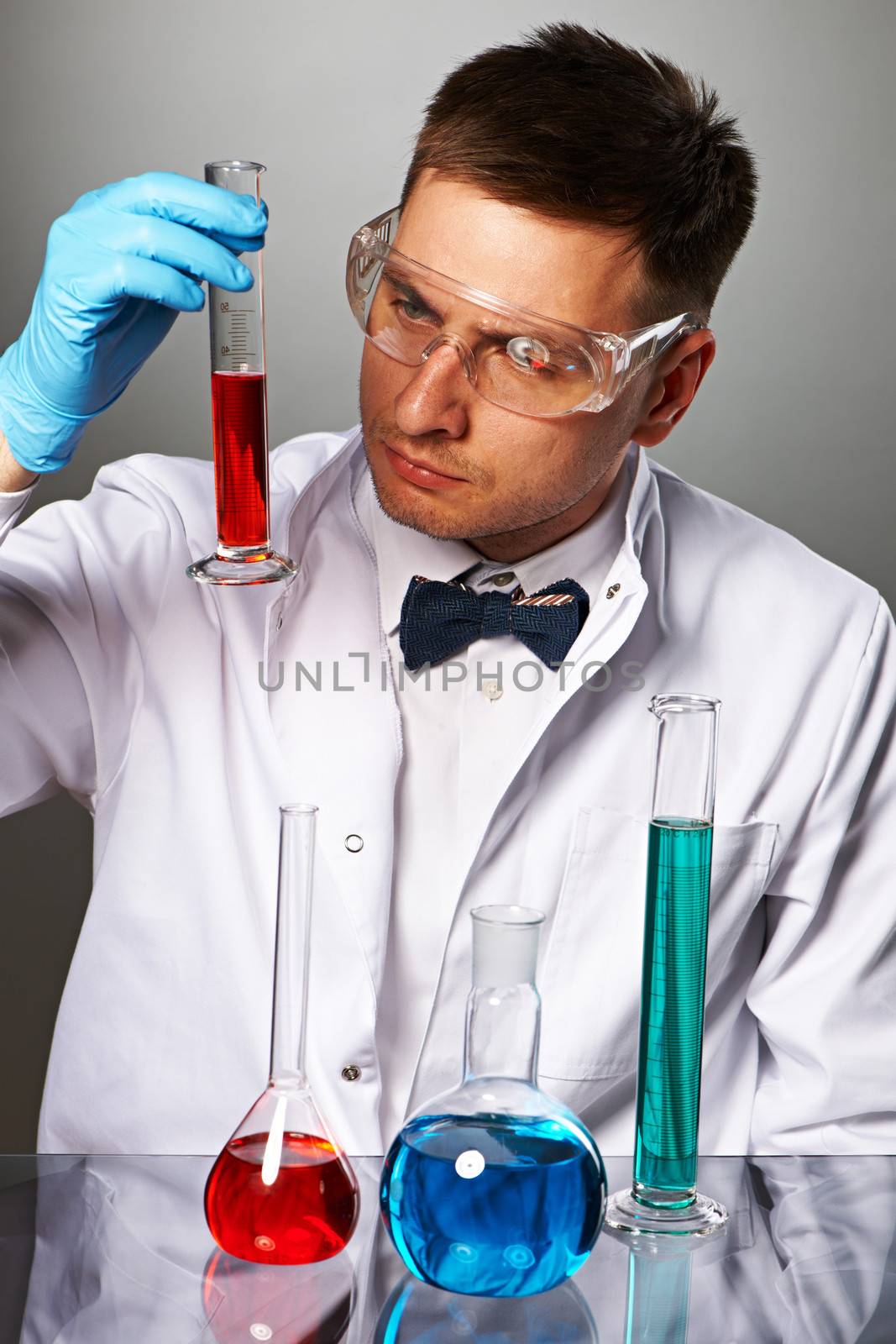 Scientist in protective glasses at laboratory