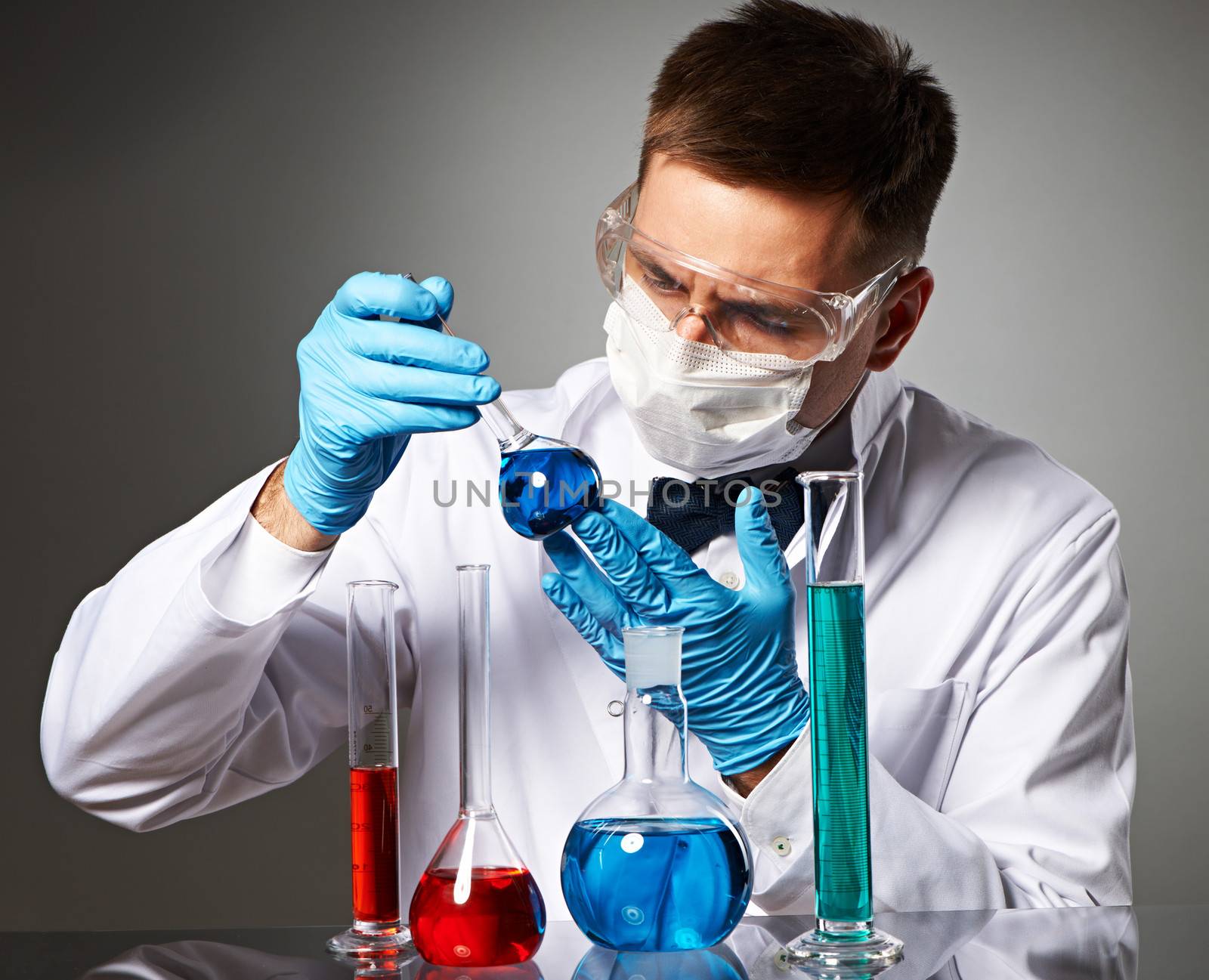 Scientist in protective glasses at laboratory