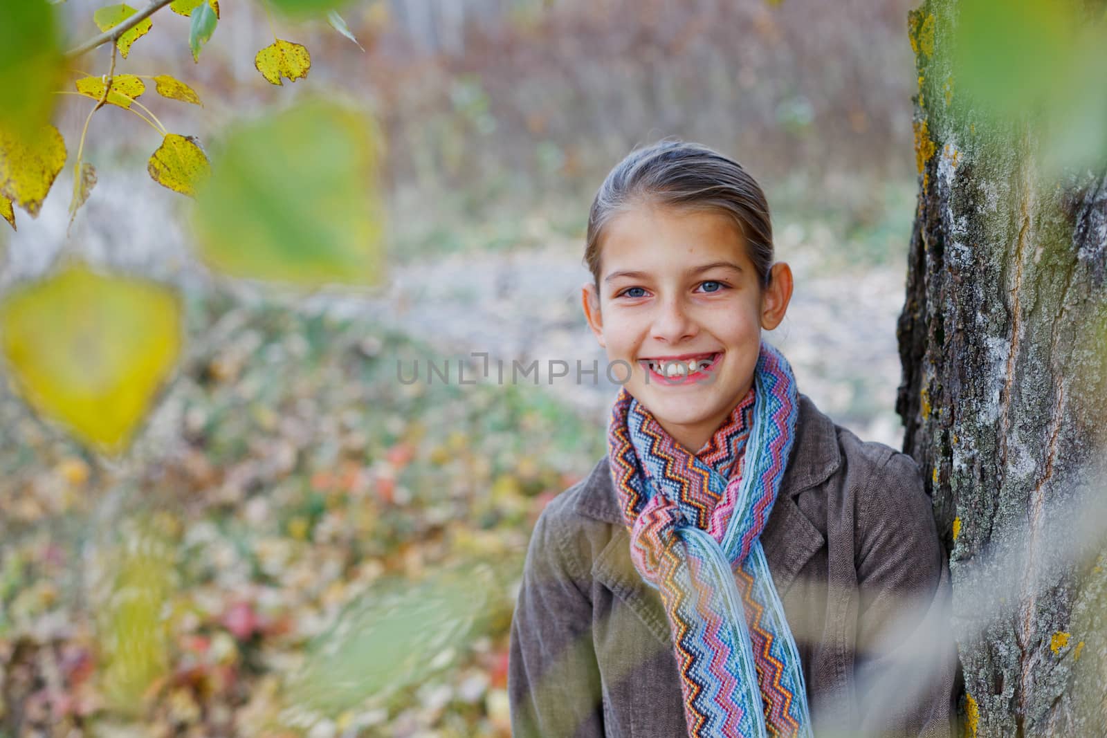 Portrait of beautiful girl walking in a autumn park