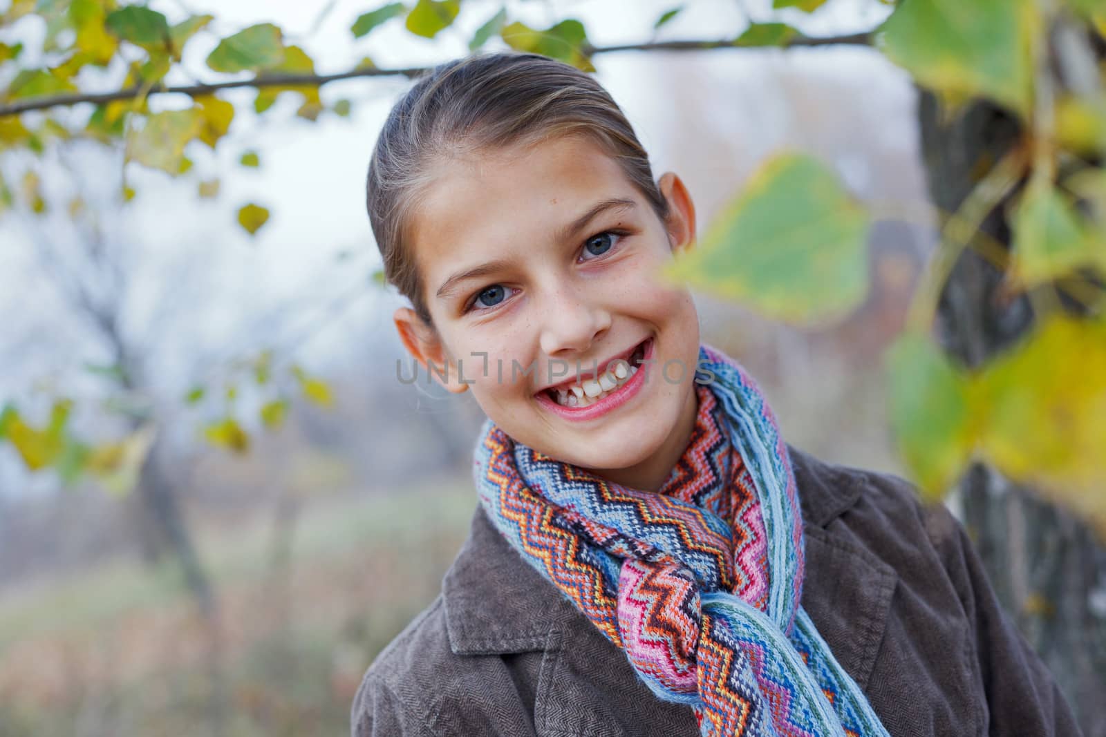 Close-up portrait of beautiful girl walking in a autumn park