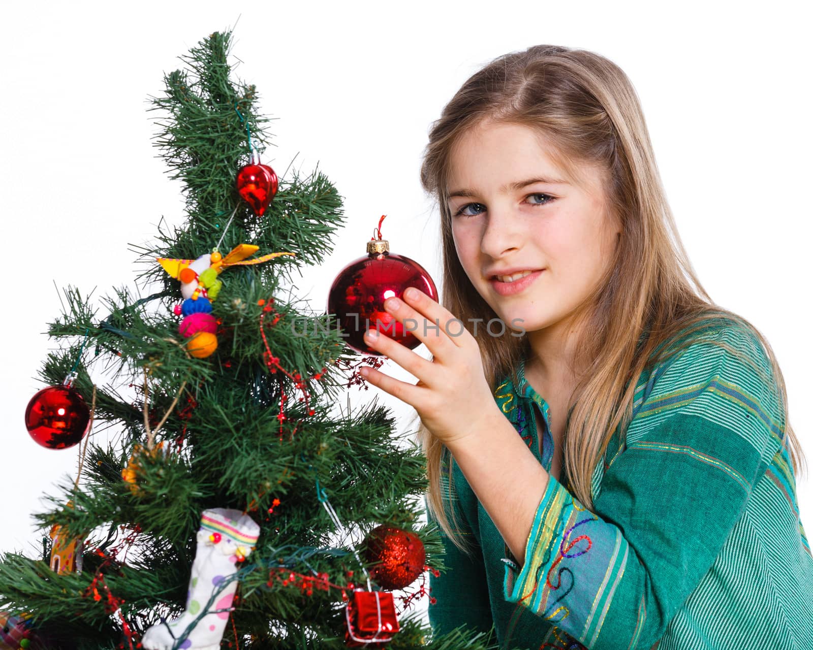 Christmas theme - Beautiful girl decorating christmas tree. Isolated on white backround.