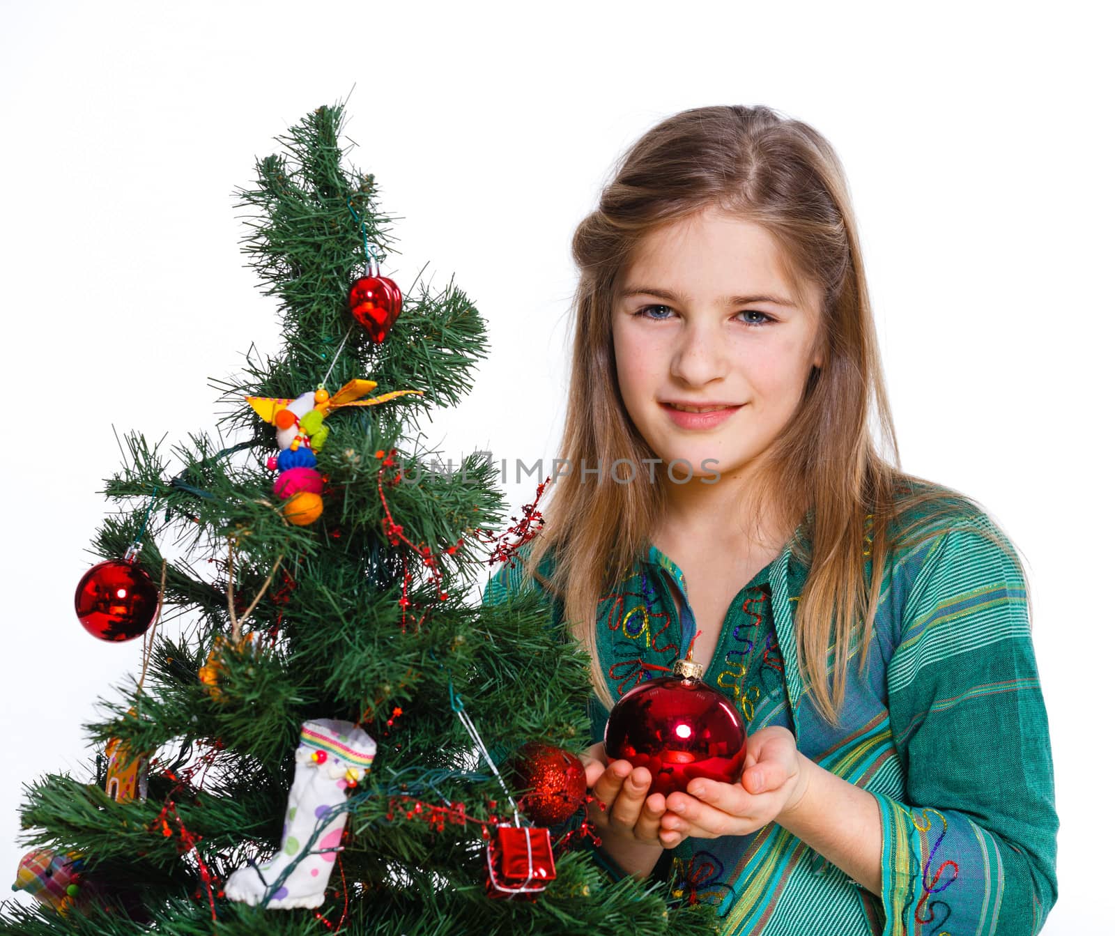 Christmas theme - Beautiful girl decorating christmas tree. Isolated on white backround.