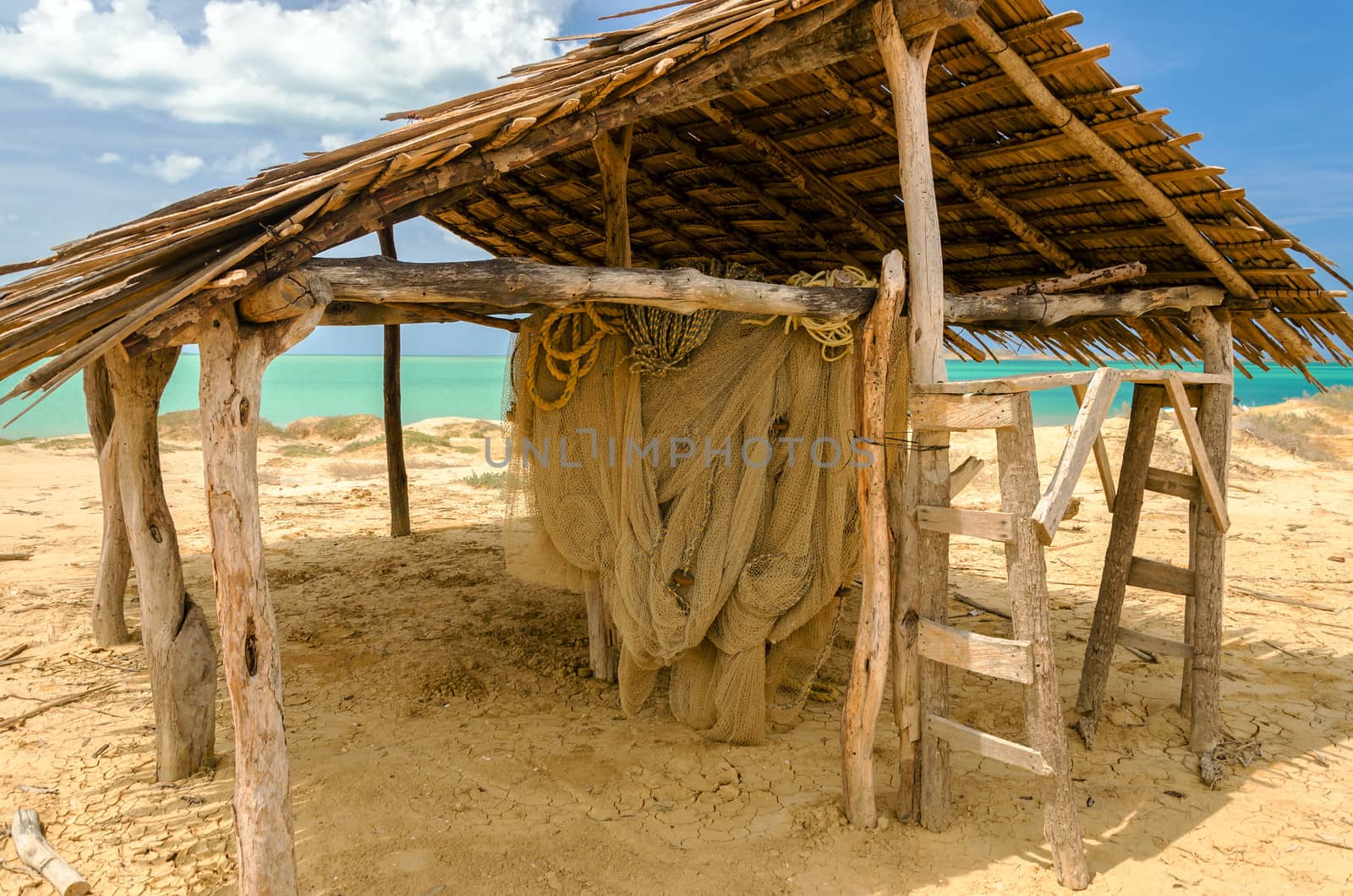 Old weathered wooden hut next to the Caribbean Sea