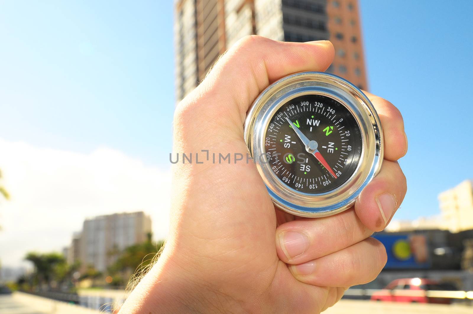 Orientation Concept a Male Hand Holding a Metal Compass in a City