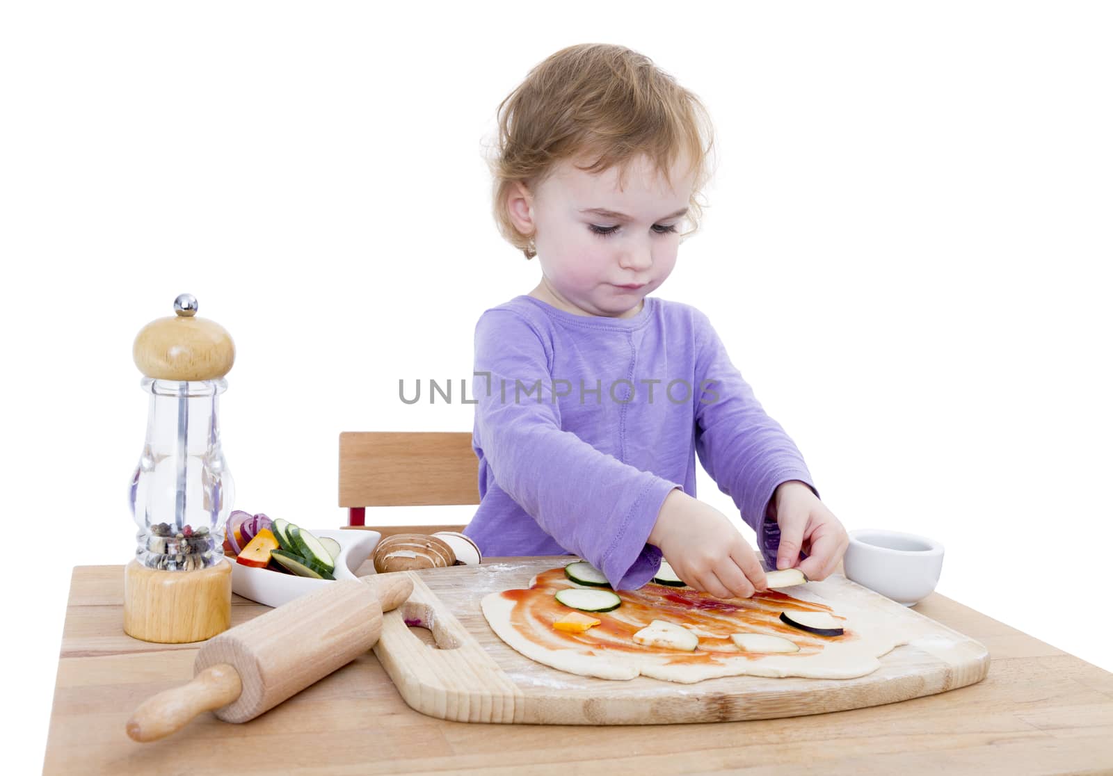 cute girl making pizza isolated in white background