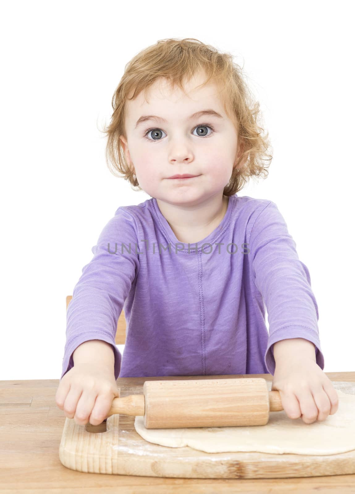 young child rolling out dough. isolated on white background