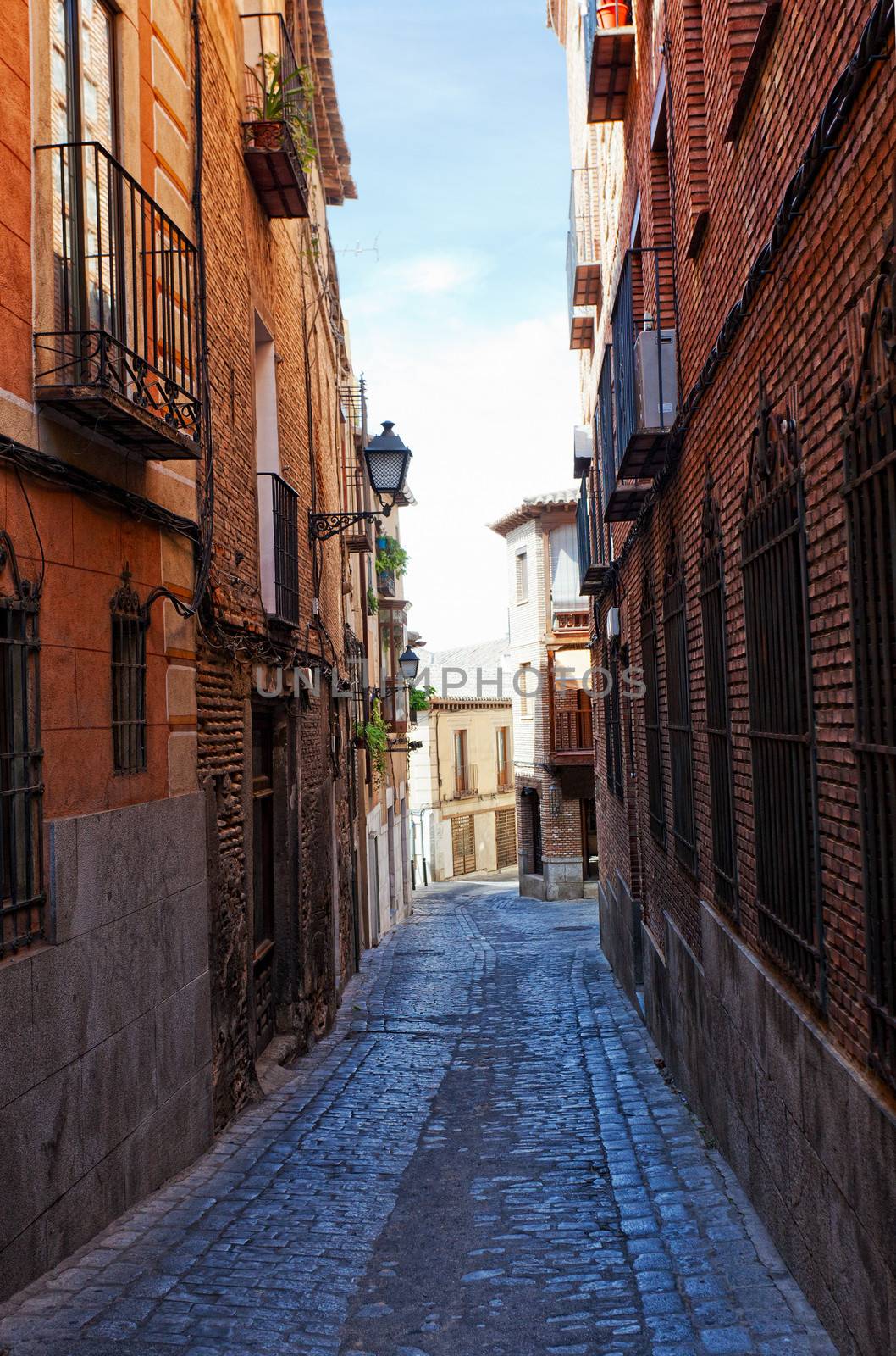 Ancient narrow small street in Toledo, Spain by elena_shchipkova