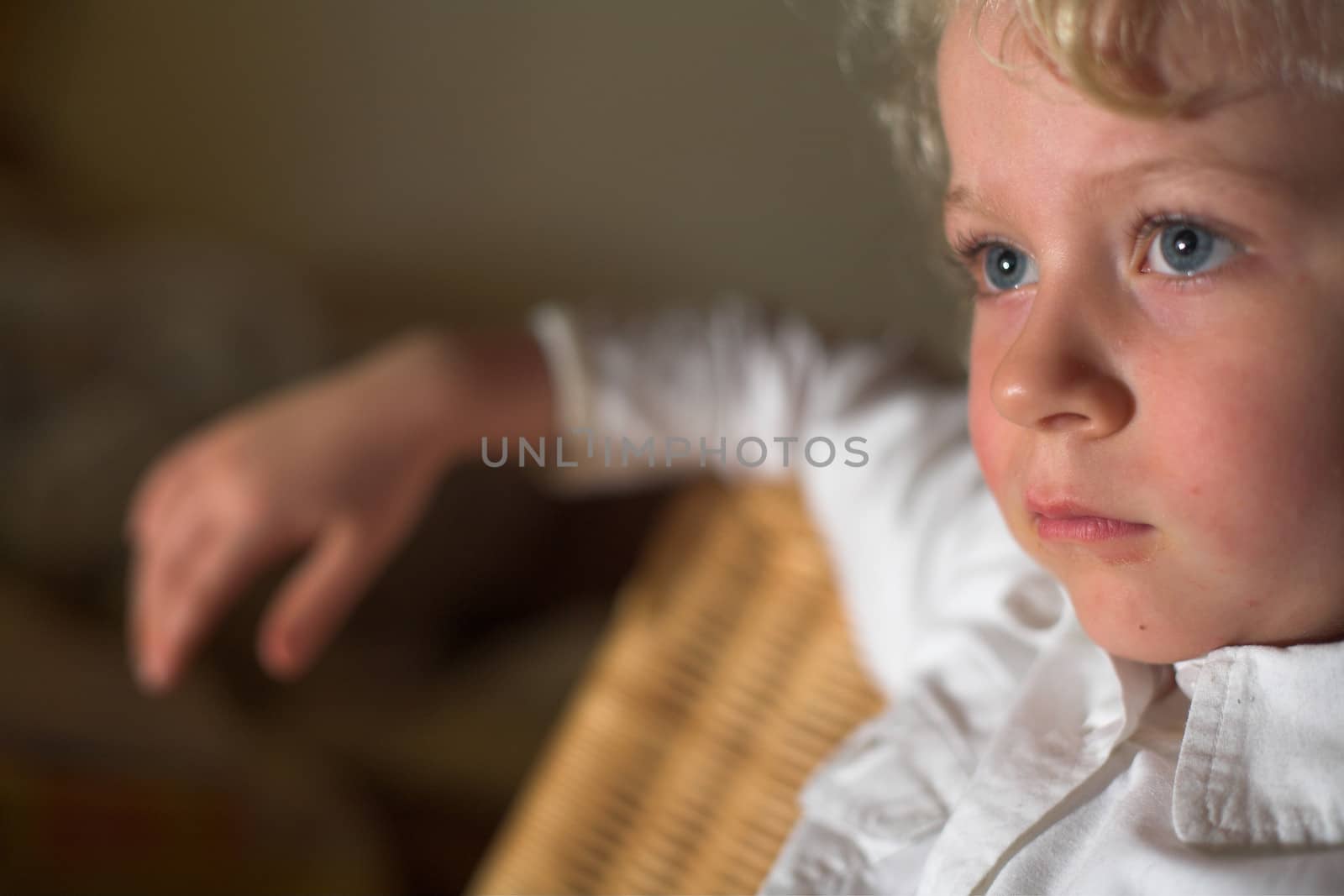  close up of child profile with blue eyes looking in front of her
