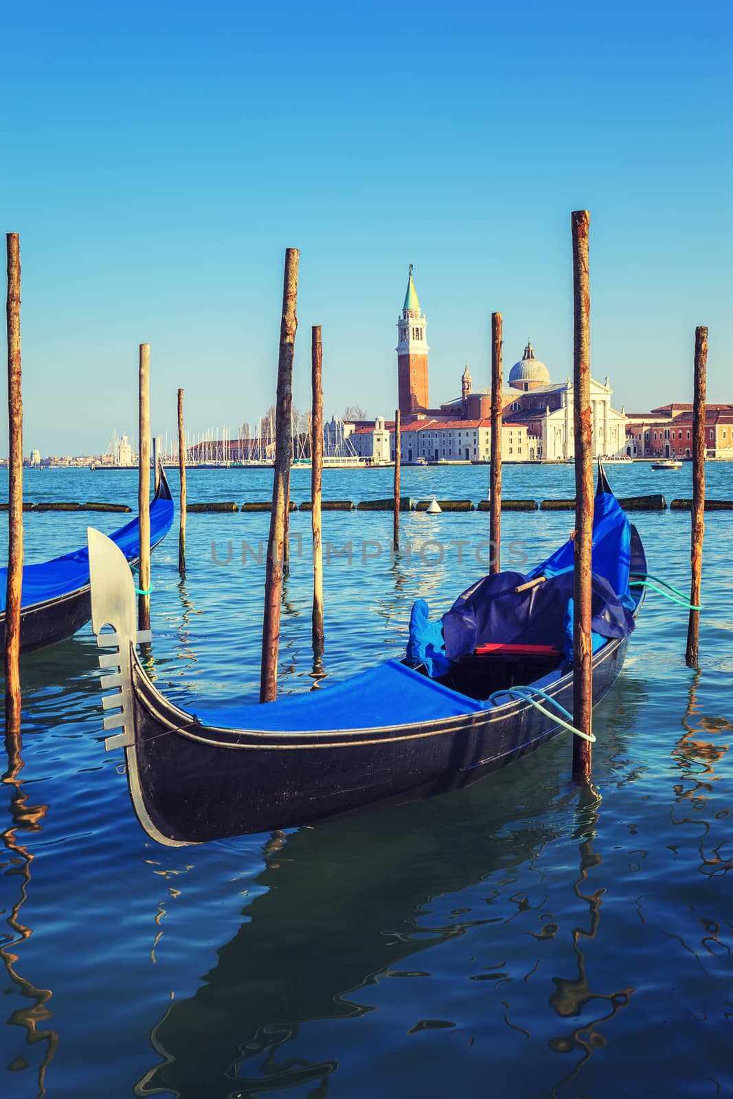 Gondolas in lagoon of Venice on sunrise, Italy 
