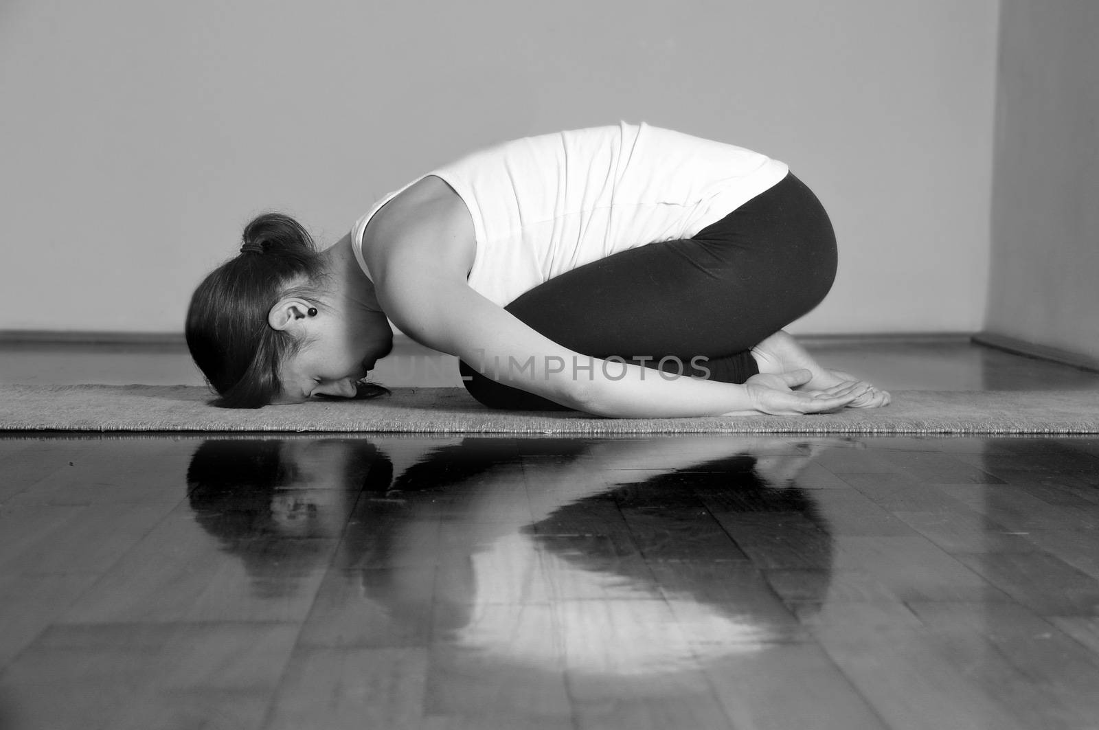 Girl doing Balasana yoga pose by anderm