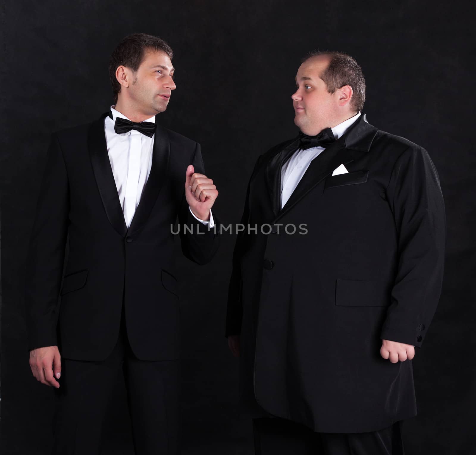 Two stylish businessman in tuxedos by Discovod