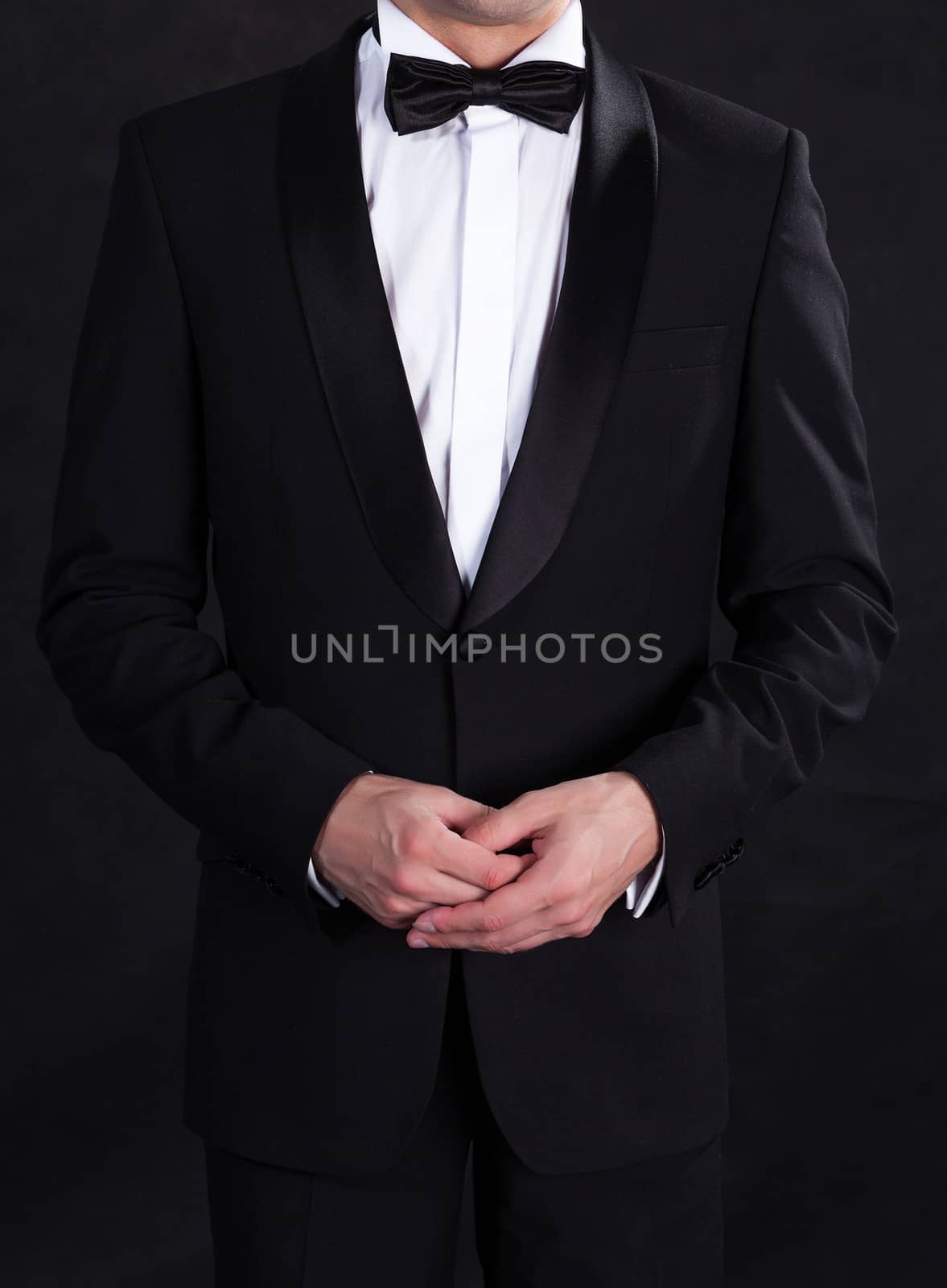Stylish man in elegant black tuxedo by Discovod