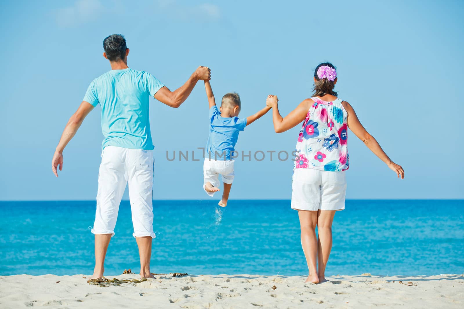Photo of happy family having fun on the beach
