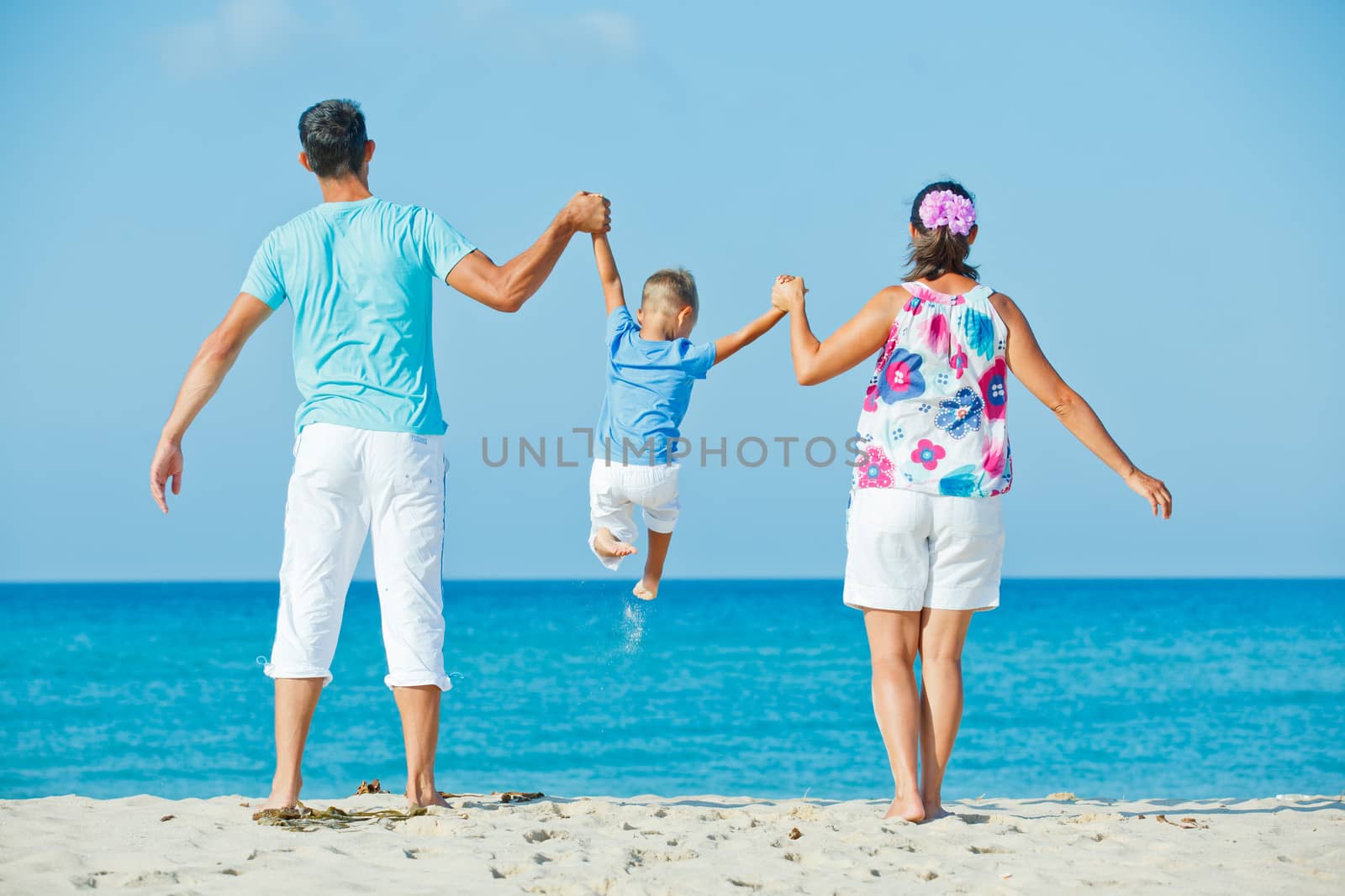 Family having fun on beach by maxoliki