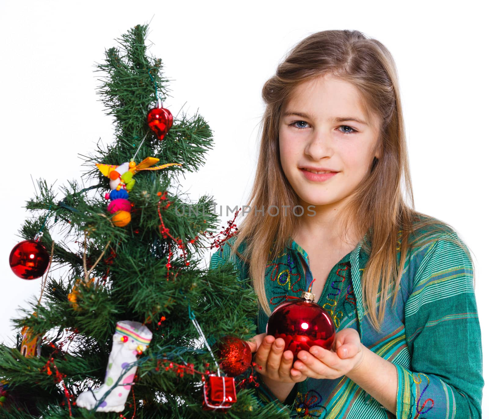 Christmas theme - Beautiful girl decorating christmas tree. Isolated on white backround.