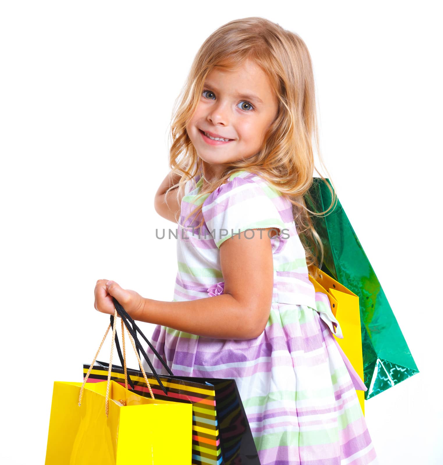 Shopping little girl happy smiling holding shopping bags isolated on white background.