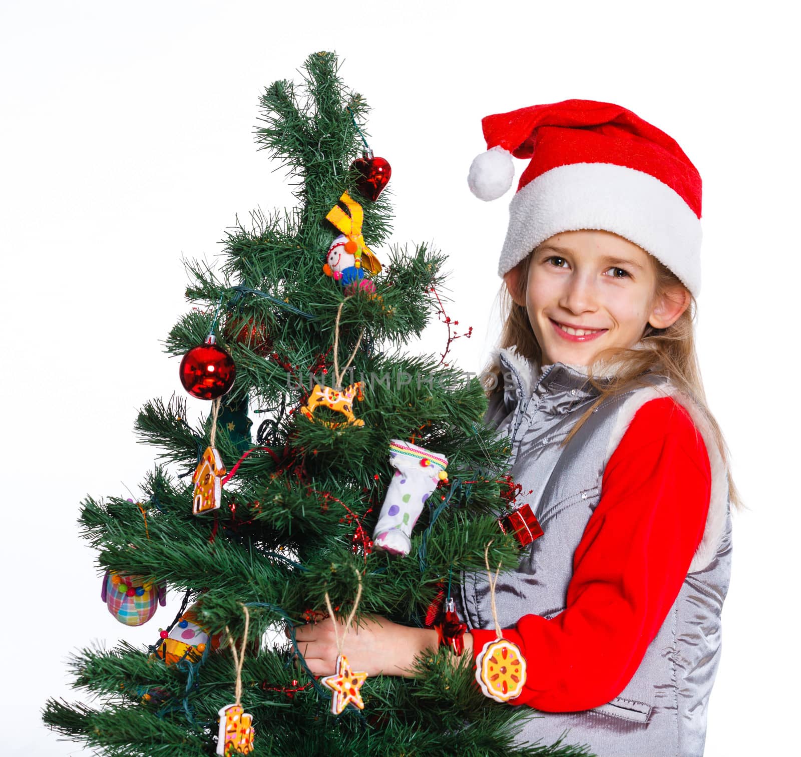 Christmas theme - Beautiful girl decorating christmas tree. Isolated on white backround.
