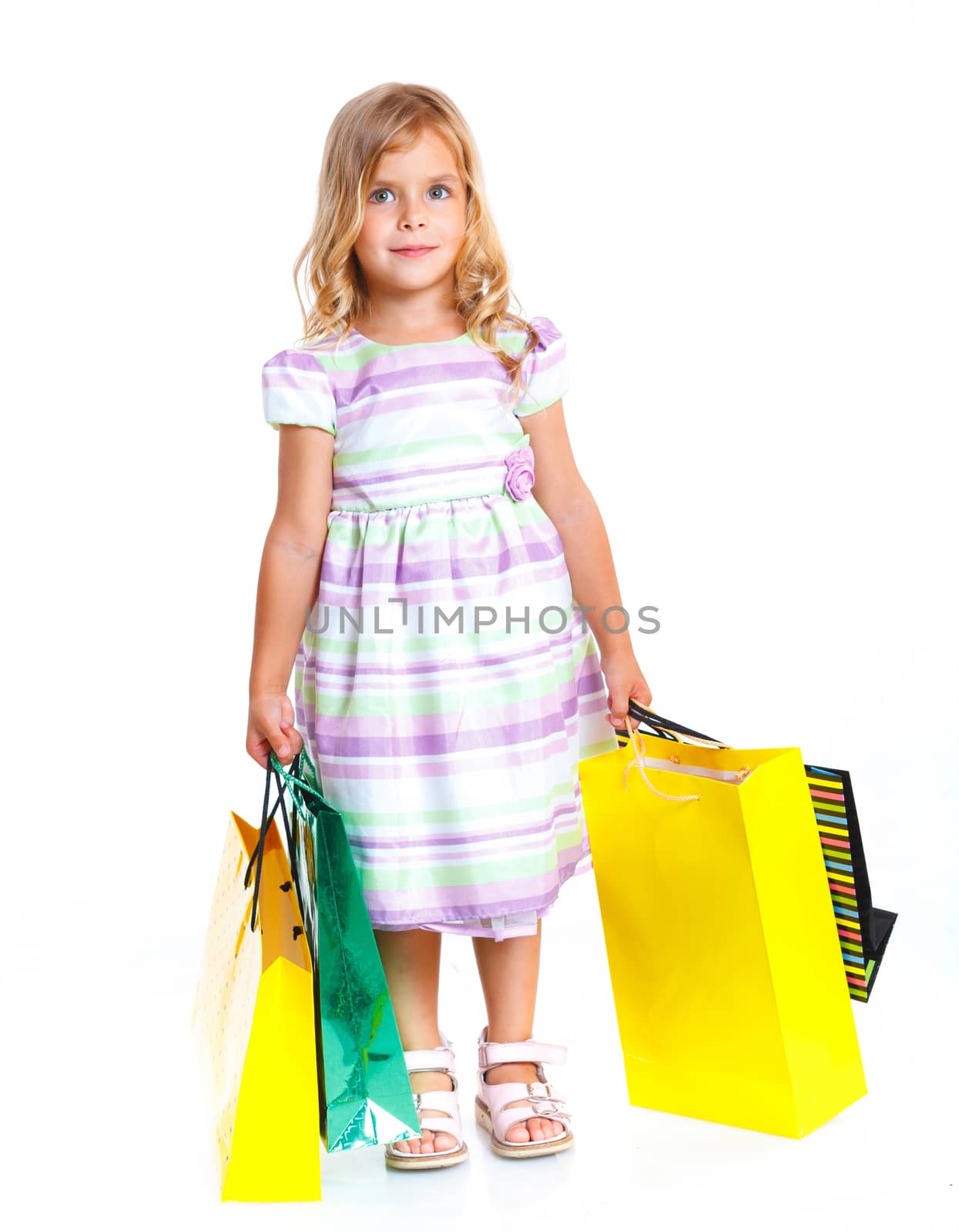 Shopping little girl happy smiling holding shopping bags isolated on white background.