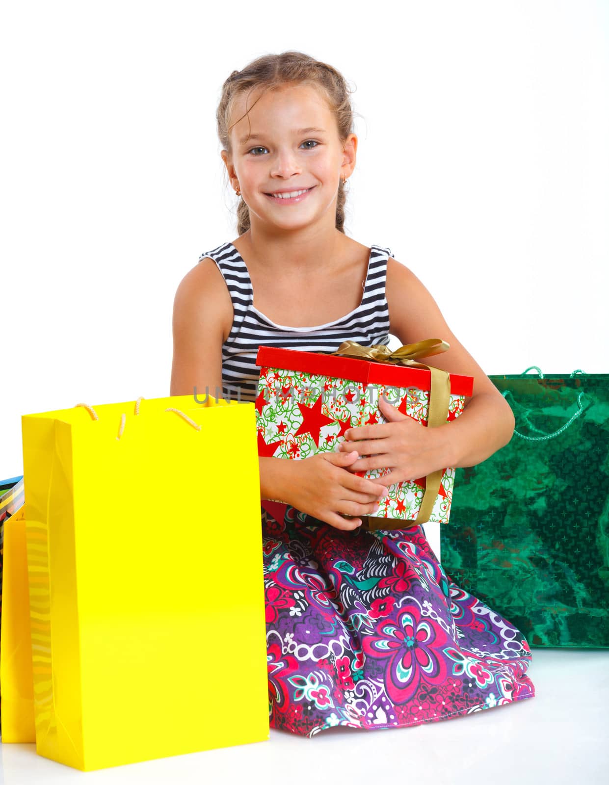 Shopping little girl happy smiling holding shopping bags isolated on white background.