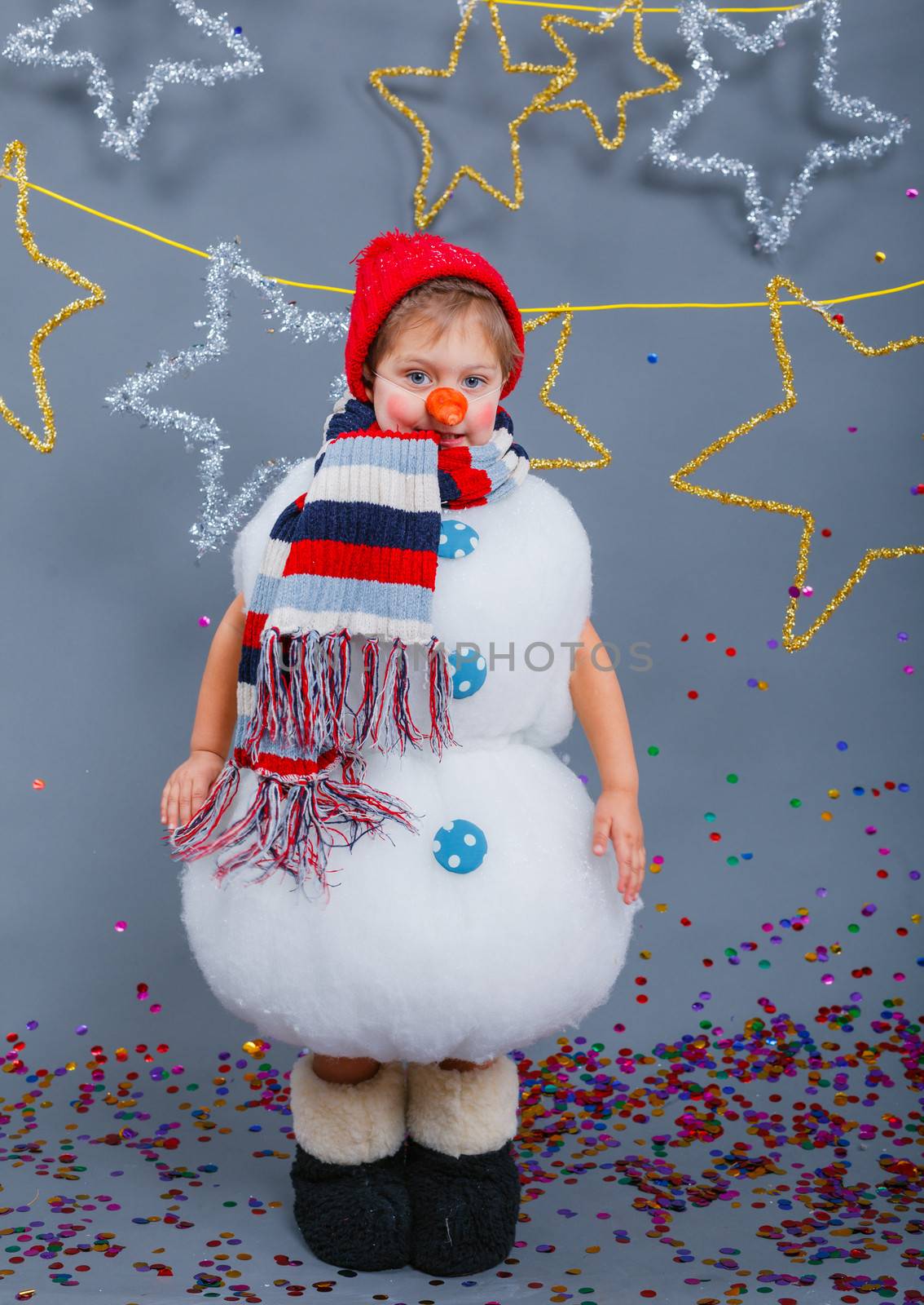 Cute little boy in suit snowman in red hat and mittens