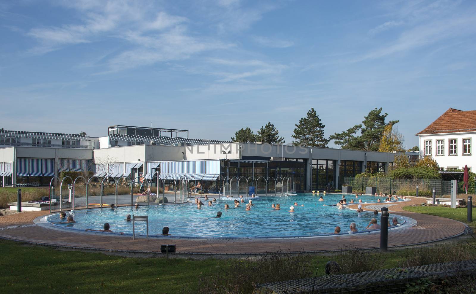 people in wellness swiming pool outside with blue sky