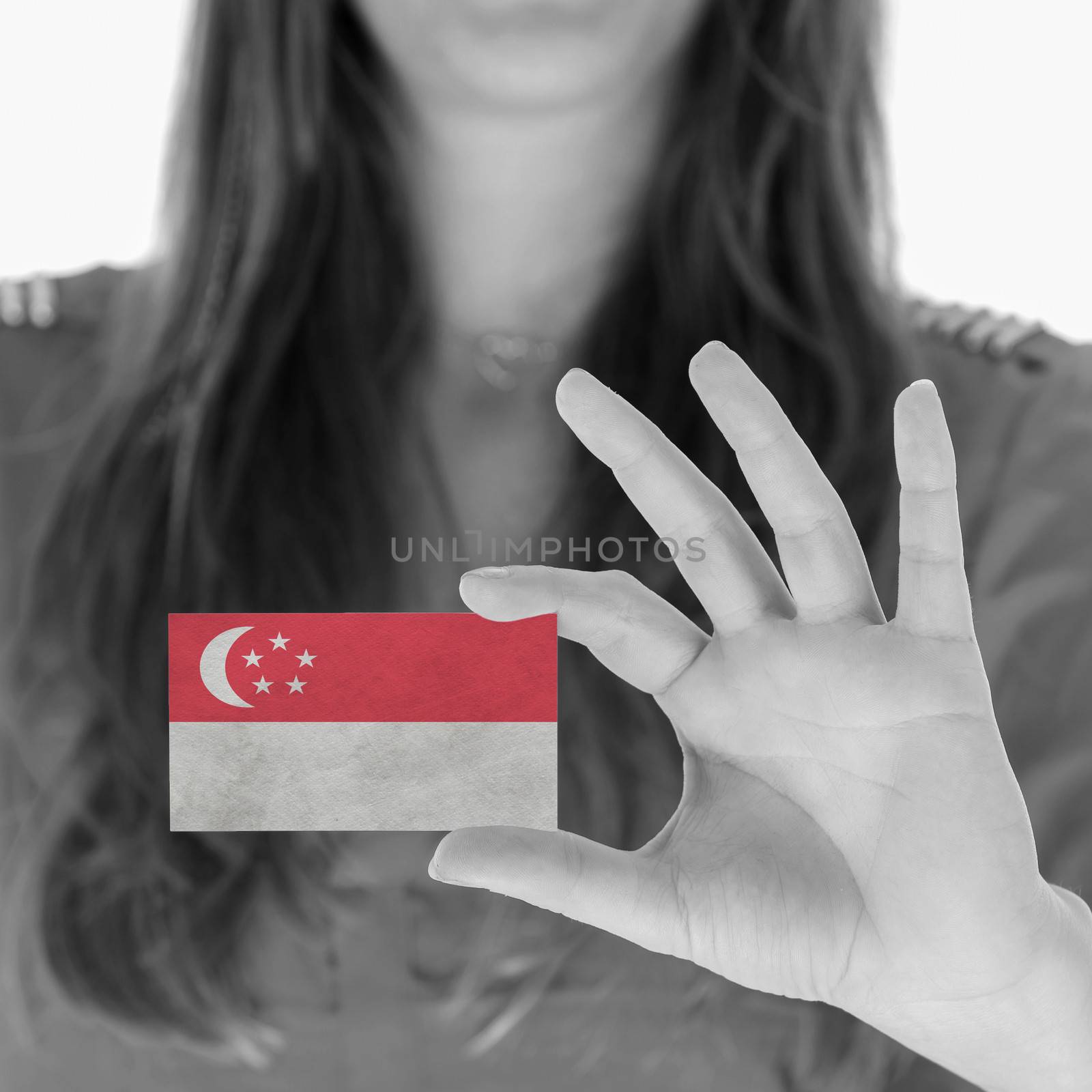 Woman in showing a business card, Singapore