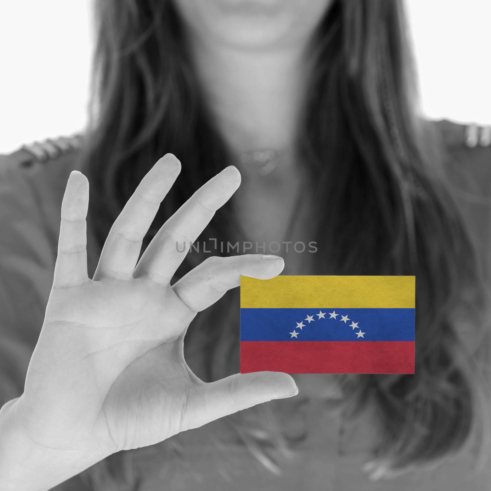 Woman showing a business card, Venezuela