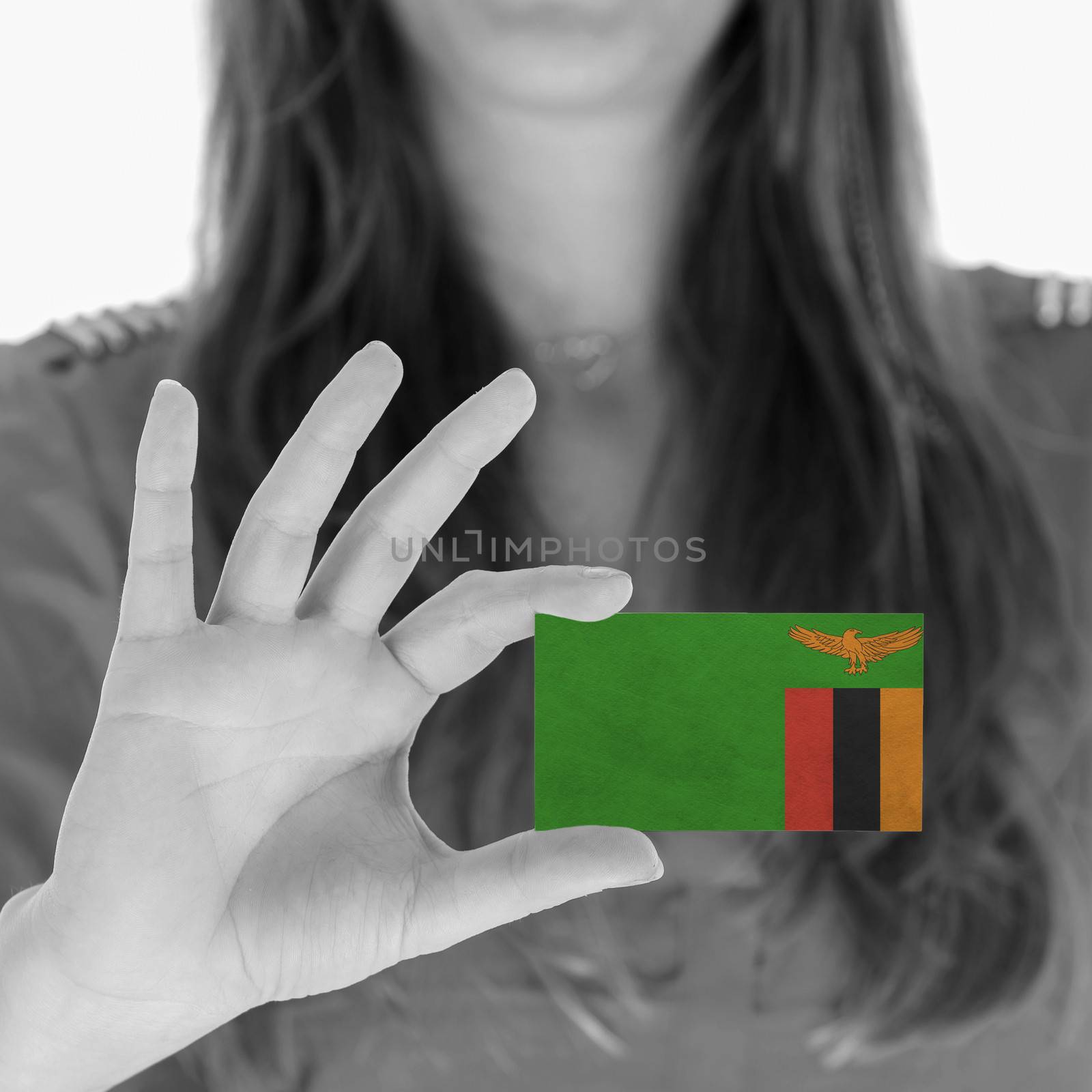 Woman showing a business card, Zambia