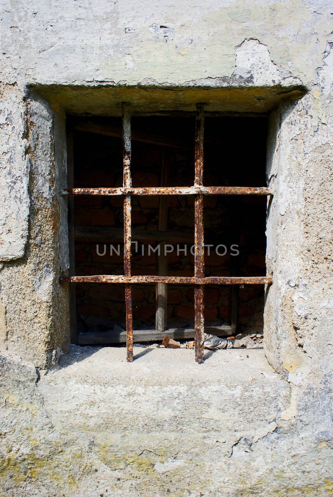 old grunge small window barred by rusty bar                   