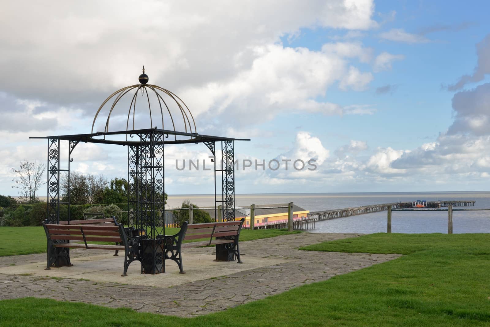 Seats overlooking coast and pier by pauws99