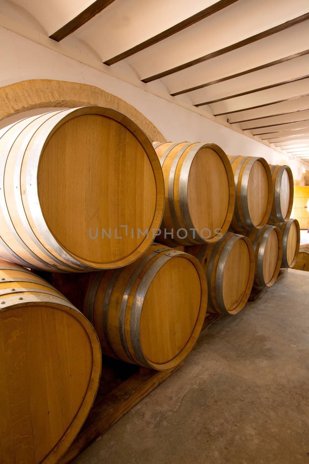 wine wooden oak barrels stacked in a row at Mediterranean winery