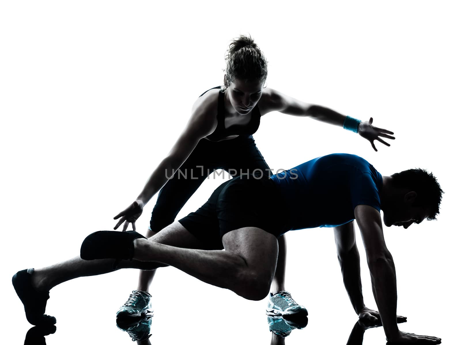 one caucasian couple man woman personal trainer coach exercising legs silhouette studio isolated on white background