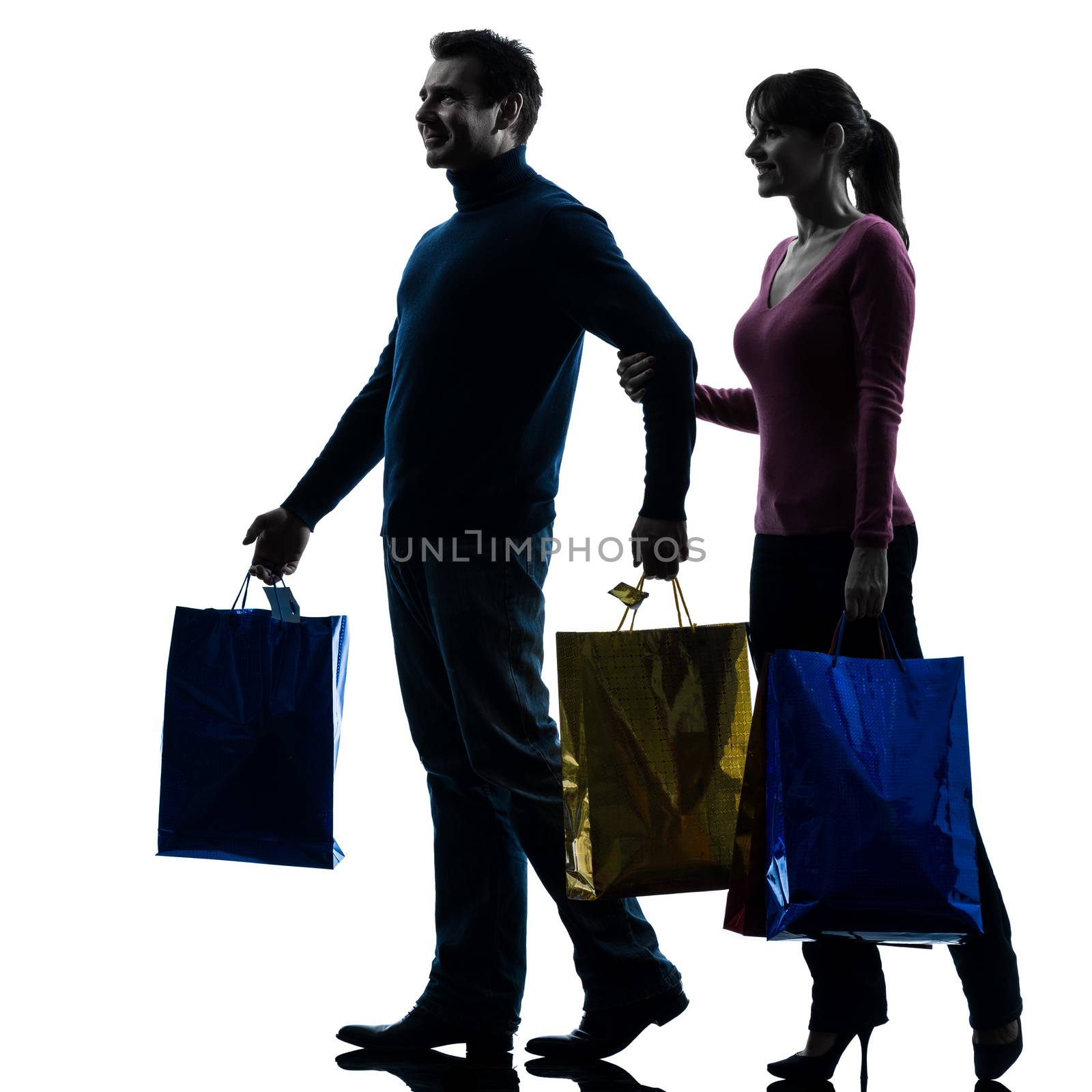 one caucasian couple woman man christmas present shopping  in silhouette studio isolated on white background