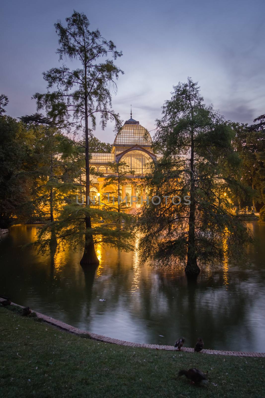 Buen Retiro park lake in Madrid with the famous crystal palace on background