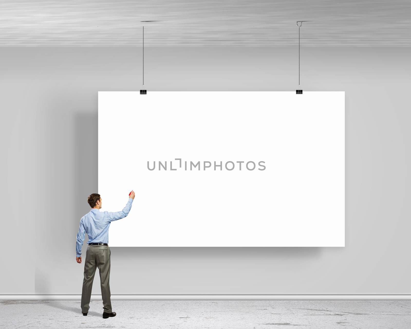 Image of businessman standing with back and writing on blank banner