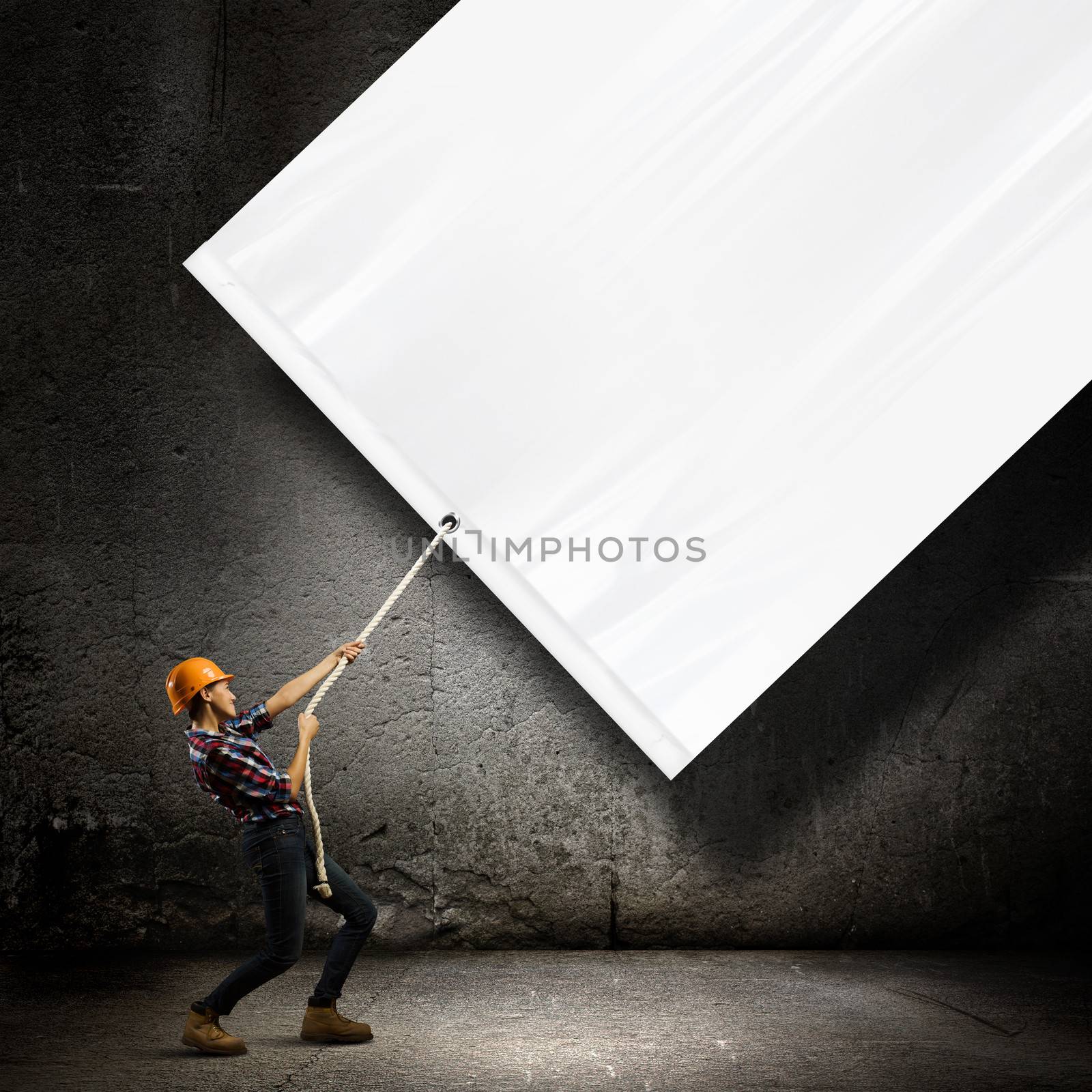 Image of woman engineer pulling blank white banner