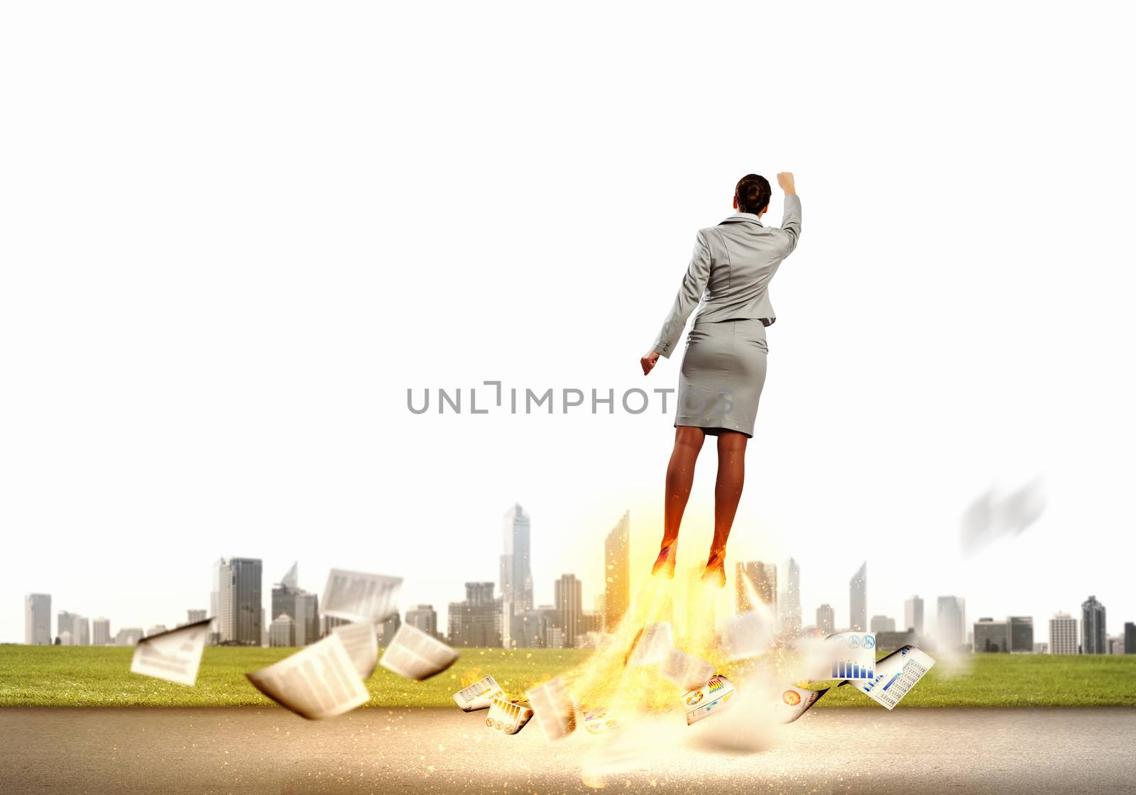 Image of businesswoman flying up into sky