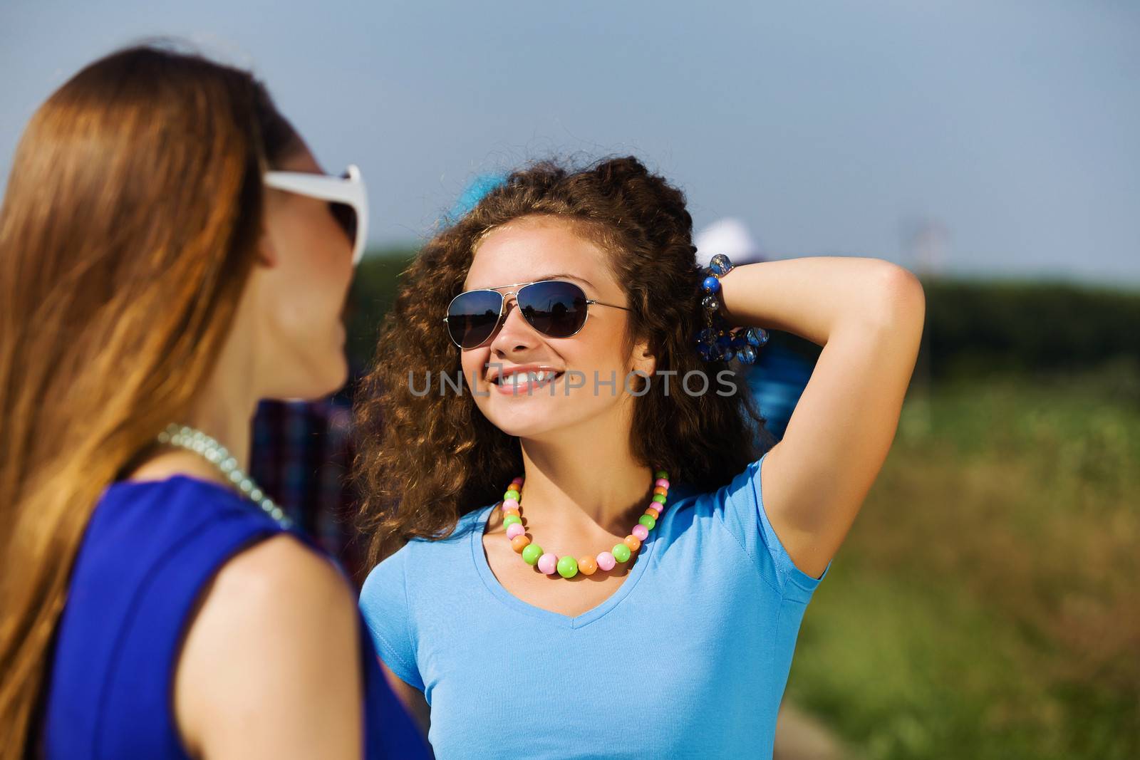 Attractive young women having fun outdoors. Summer vacation