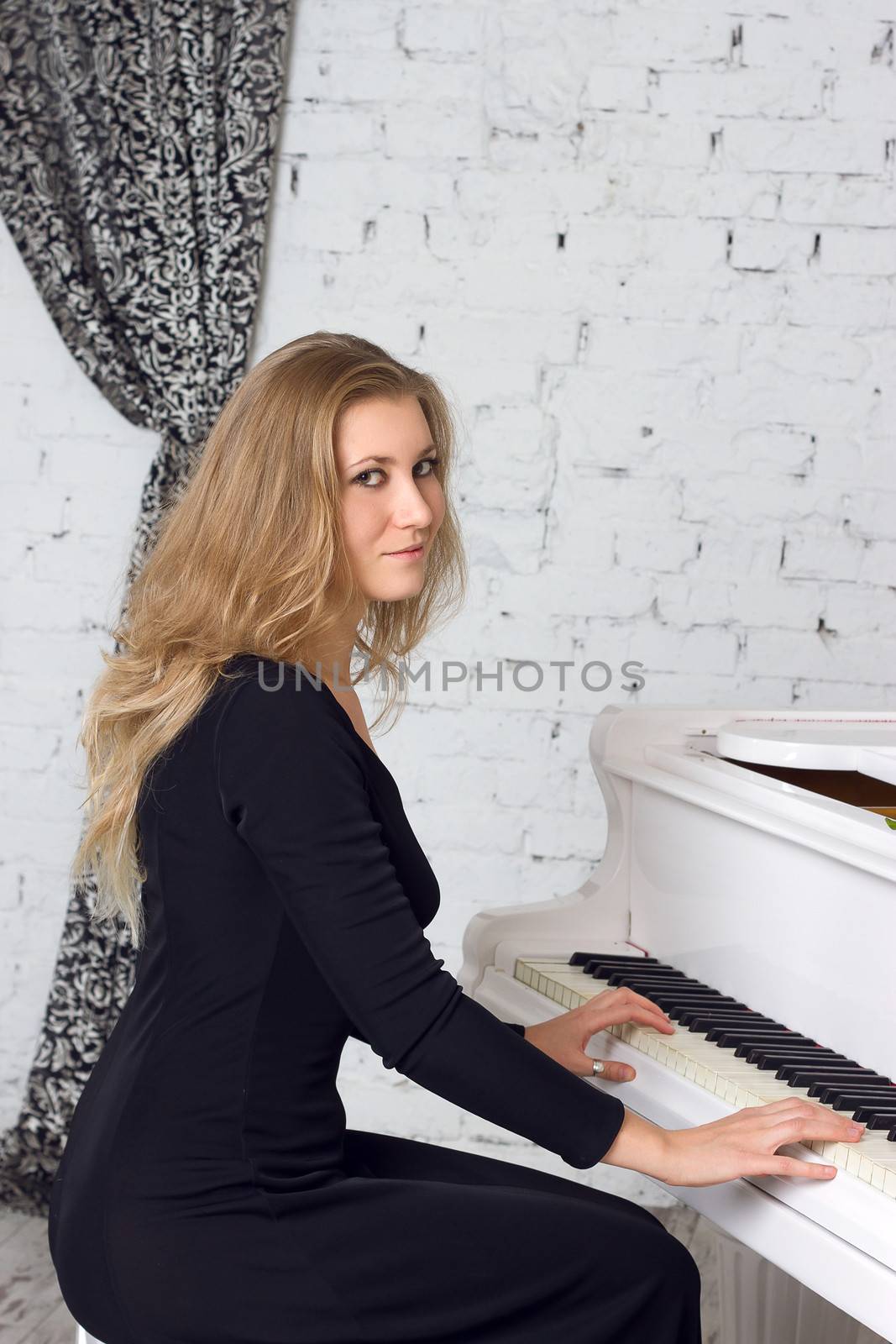 Beautiful middle eastern girl playing piano